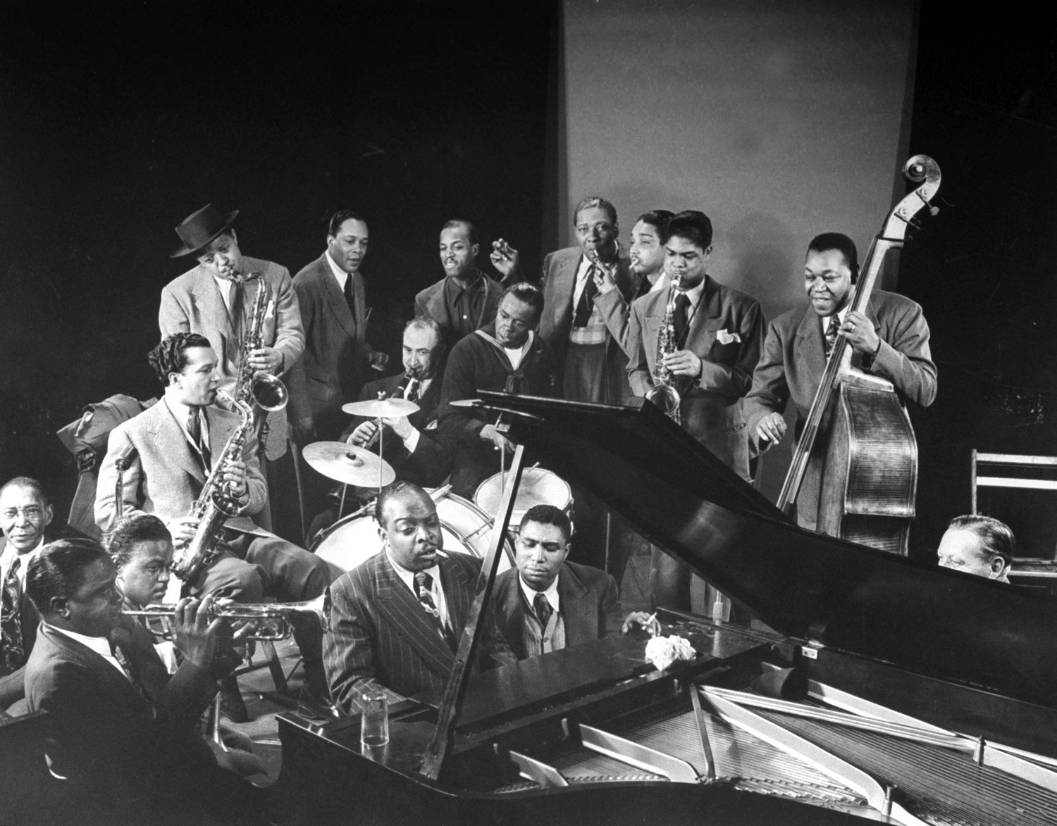 Jazz jam session, including Lester Young (standing, in hat) on saxophone and Count Basie at the piano, 1943.