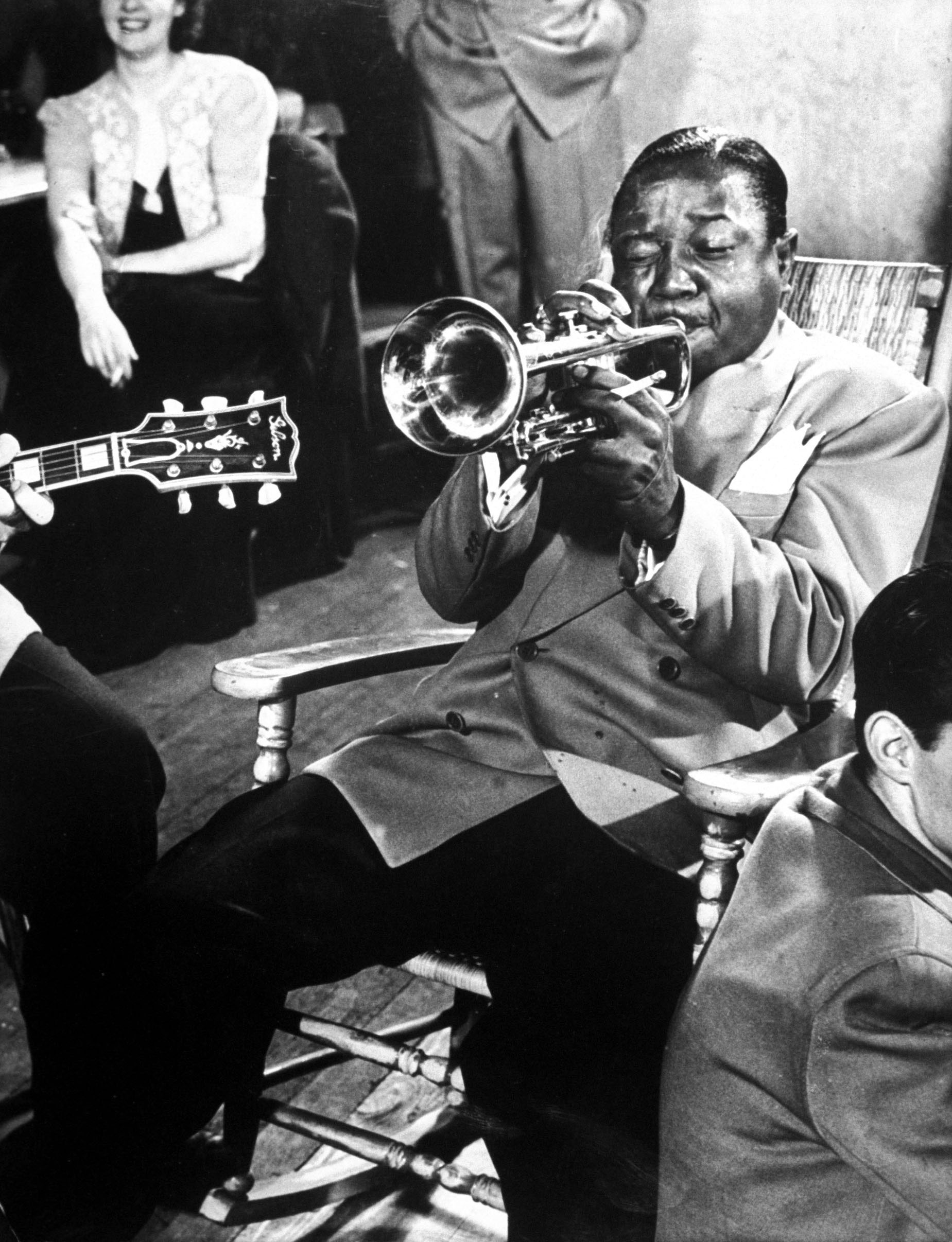 The one and only Roy Eldridge plays trumpet during drummer Gene Krupa's jam session at Gjon Mili's studio, 1940s.