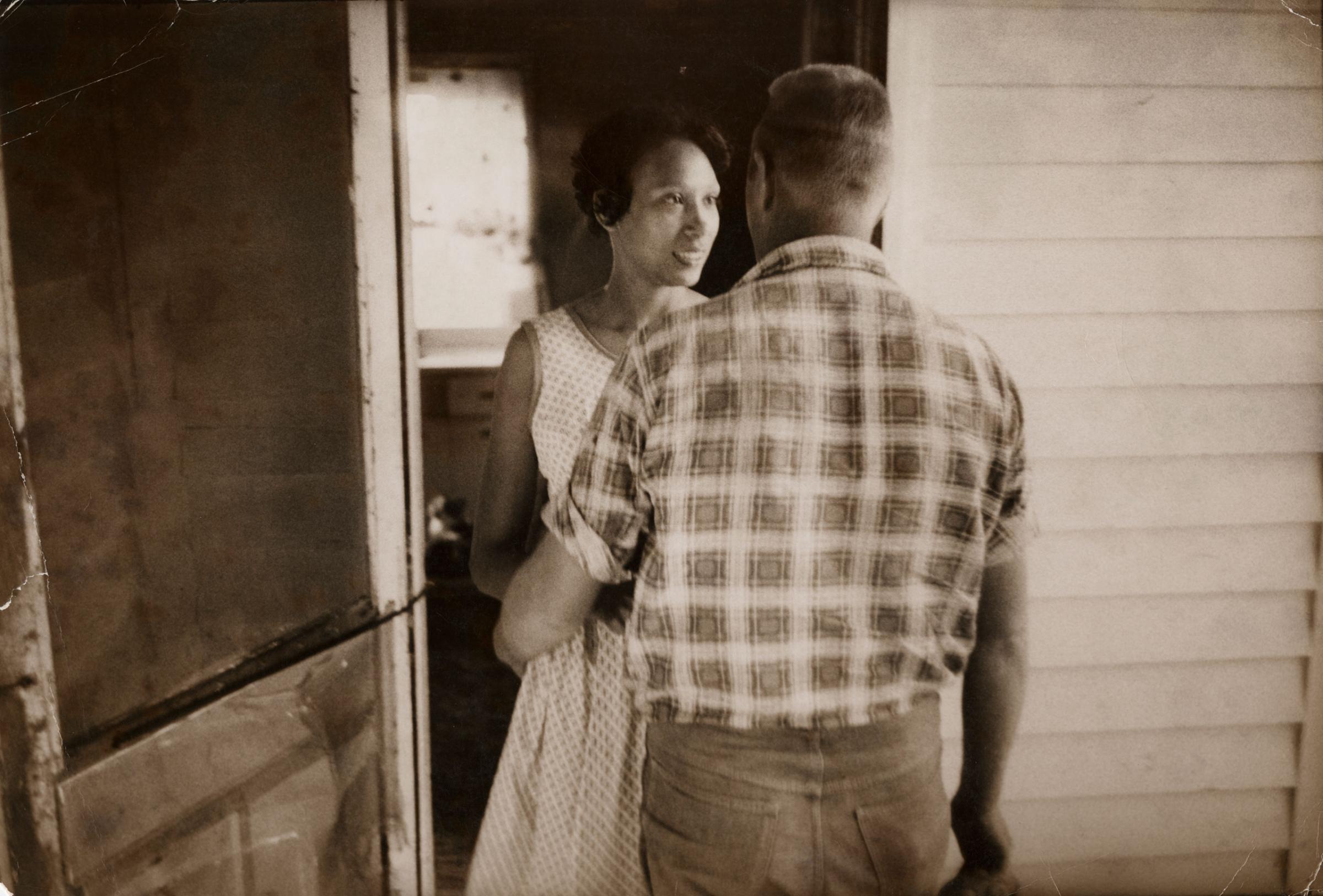 Mildred Loving greets her husband Richard on their front porch, King and Queen County, Virginia, April 1965.