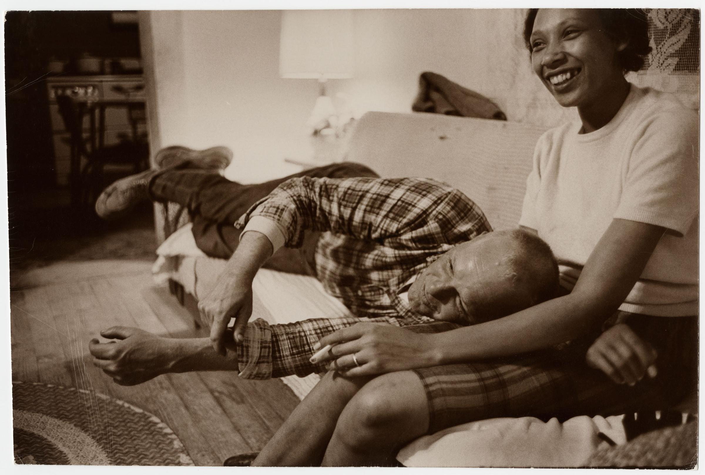 Richard and Mildred Loving laugh while watching television in their living room, King and Queen County, Virginia, April 1965.