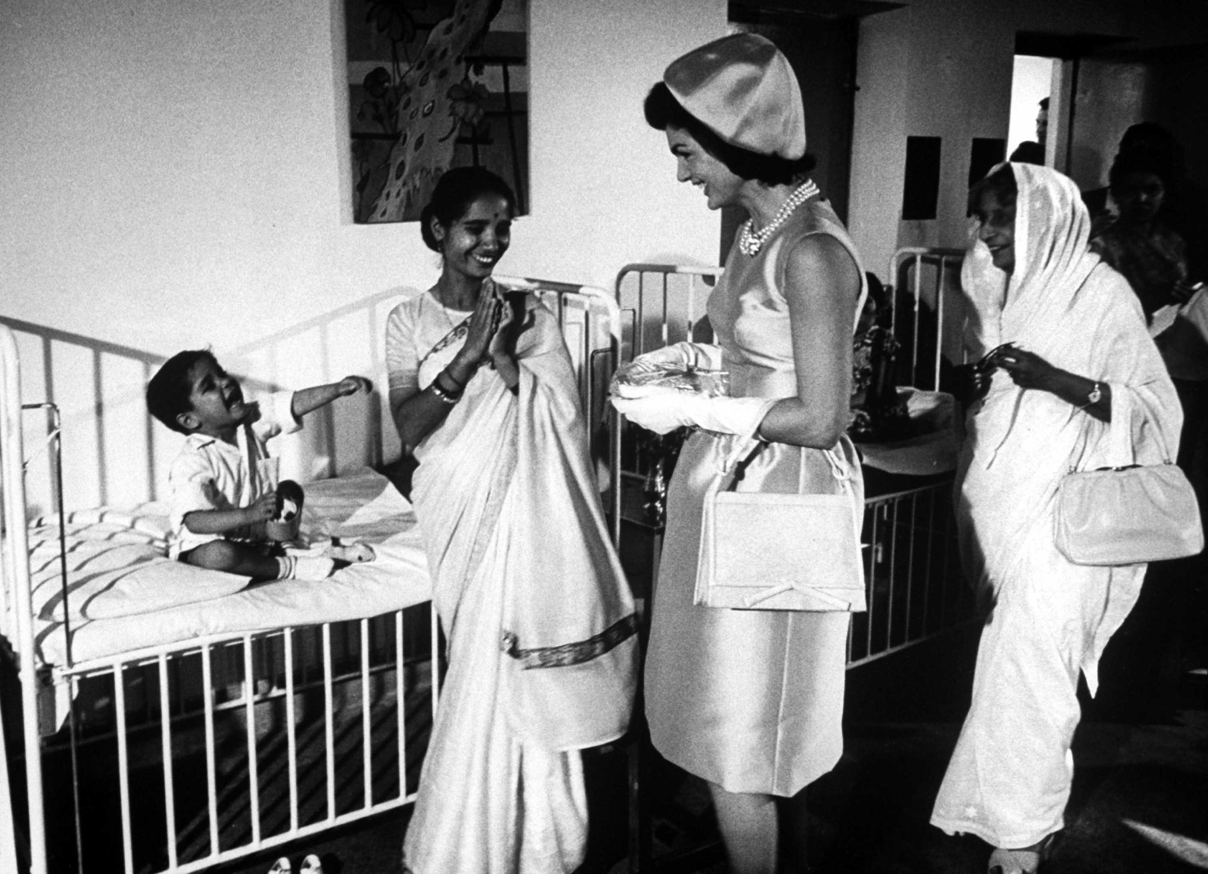 Jackie Kennedy visits children in a hospital during her tour of India in March 1962.