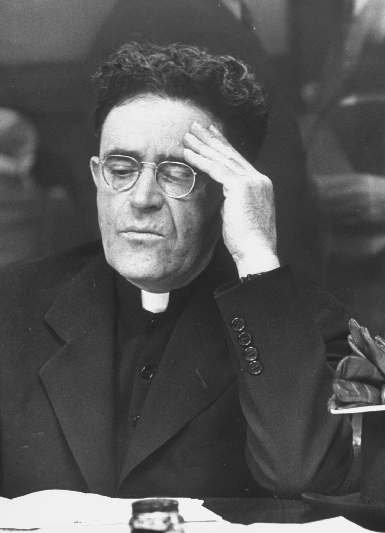 A priest at an Internal Revenue information center in New York in 1944.