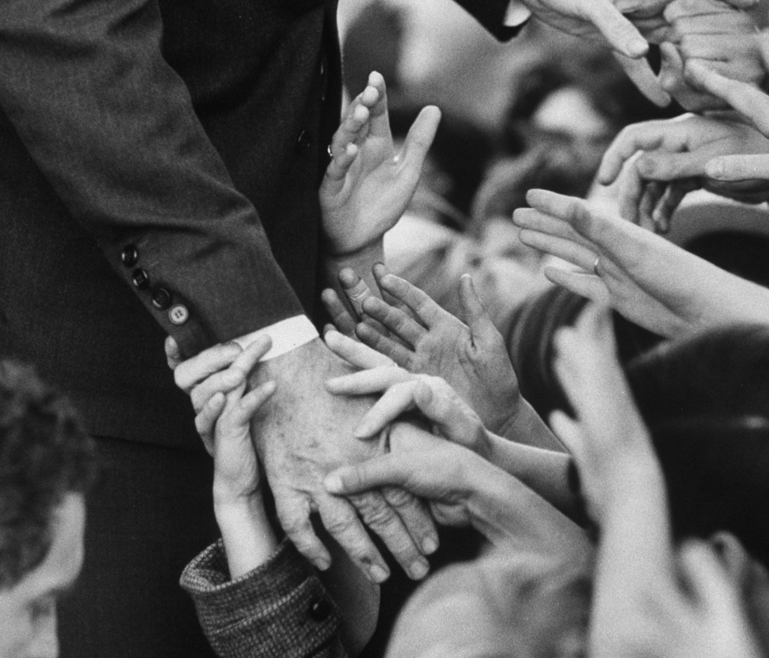 Sen. Robert F. Kennedy shakes hands with admirers in October 1966.