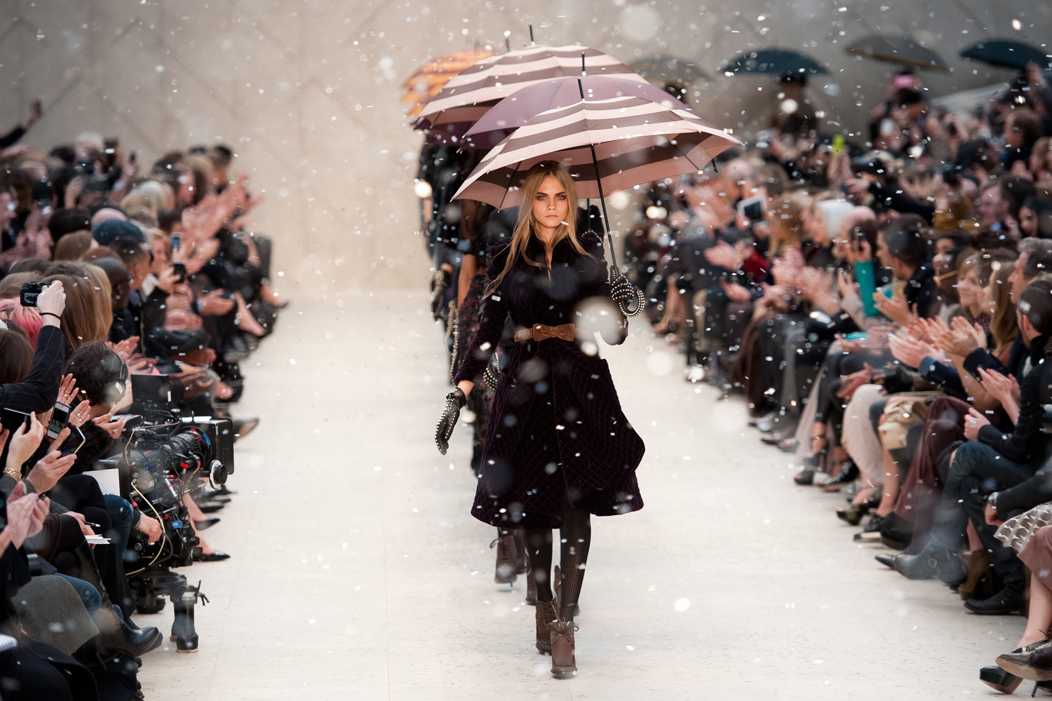Feb. 20, 2012. Models carry umbrellas through plastic  rain  during the finale of the Burberry Prorsum London 2012 Autumn/Winter collection catwalk show at London Fashion Week in central London.