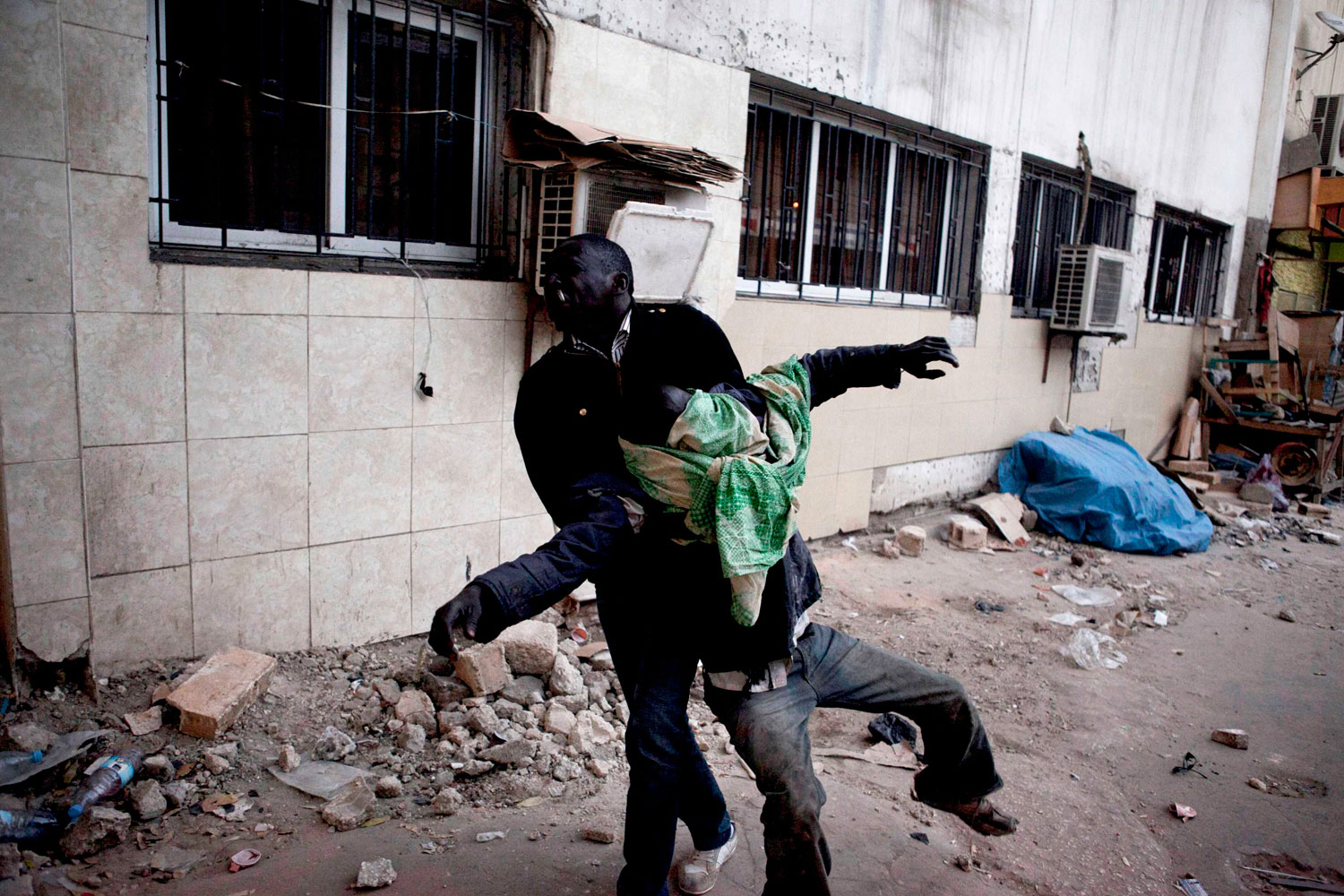 February 21, 2012. An anti-government protestor carries another injured protestor during clashes with police in Senegal's capital Dakar. Hundreds of opposition supporters clashed with Senegalese security forces in the capital on Tuesday as European Union observers criticised a ban on protests and an African envoy jetted in to try and stem rising violence.