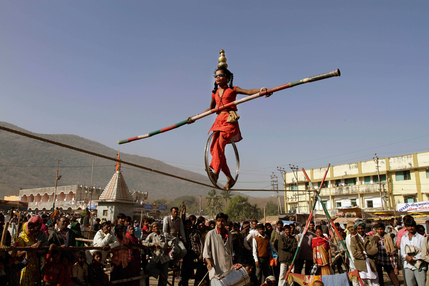 Feb. 20, 2012. An Indian girl performs acrobatic skills on a rope during Mahashivratri festival celebrations at Bhavnath temple in Junagadh, about 327 km (204 miles) from Ahmedabad, India.