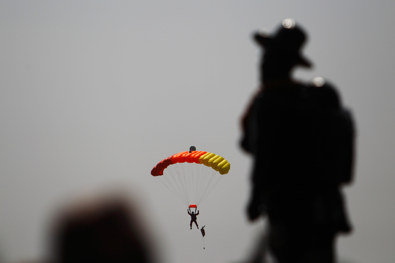 Feb. 20, 2012. A member of the Nepalese army on a parachute demonstrates his skills during the Army Day celebration in Kathmandu.
