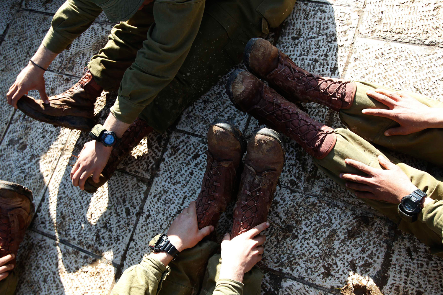 Feb. 20, 2012. Israeli soldiers stretch after completing an overnight march in Jerusalem.