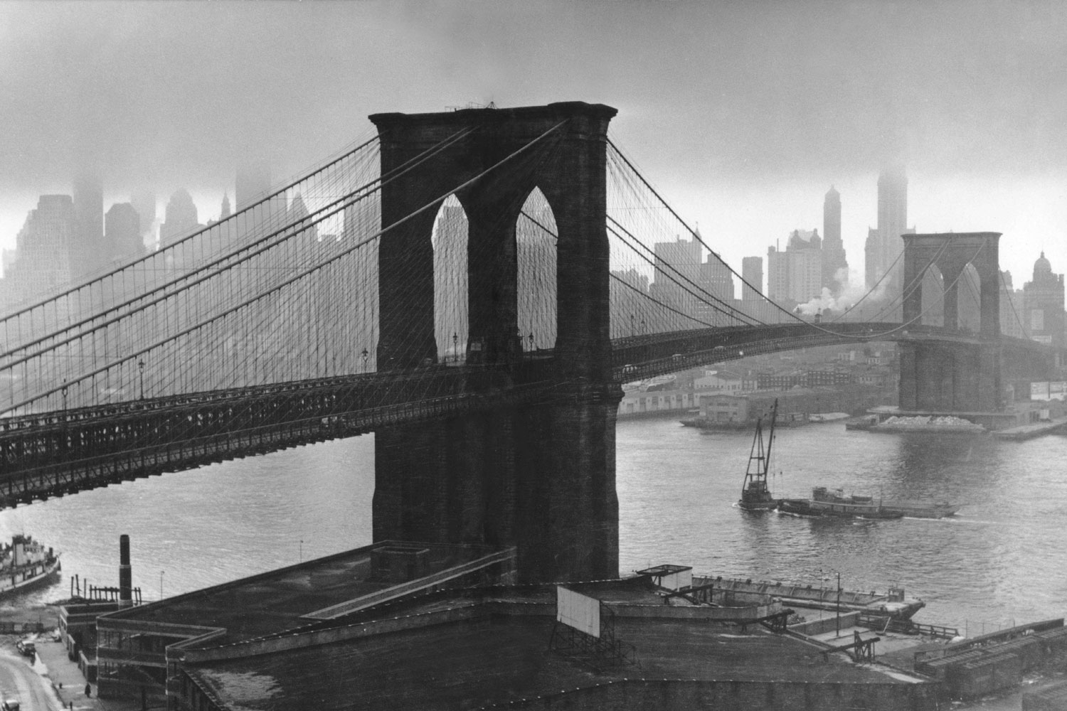 Stormy sky hovers over the Brooklyn Bridge and the ghostly skyscrapers of Manhattan's financial district in March 1946.