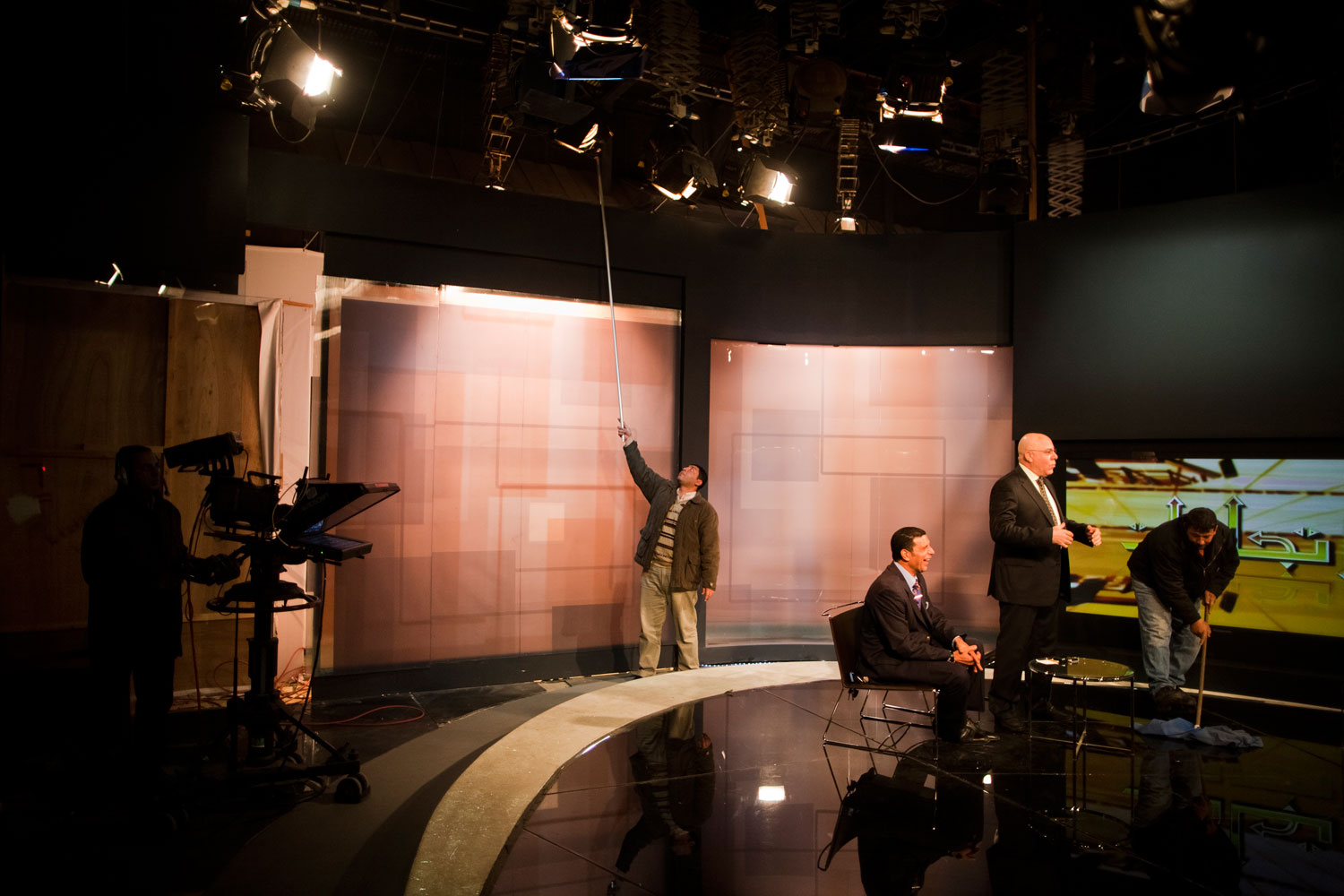 A studio TV crew prepares for the program 'Direction,' presented by Amro Shinawi, in the TV building where over 20 state TV programs are produced. Approximately 46,000 people work inside the building and are protected by barbed wire and Republican Guard soldiers.