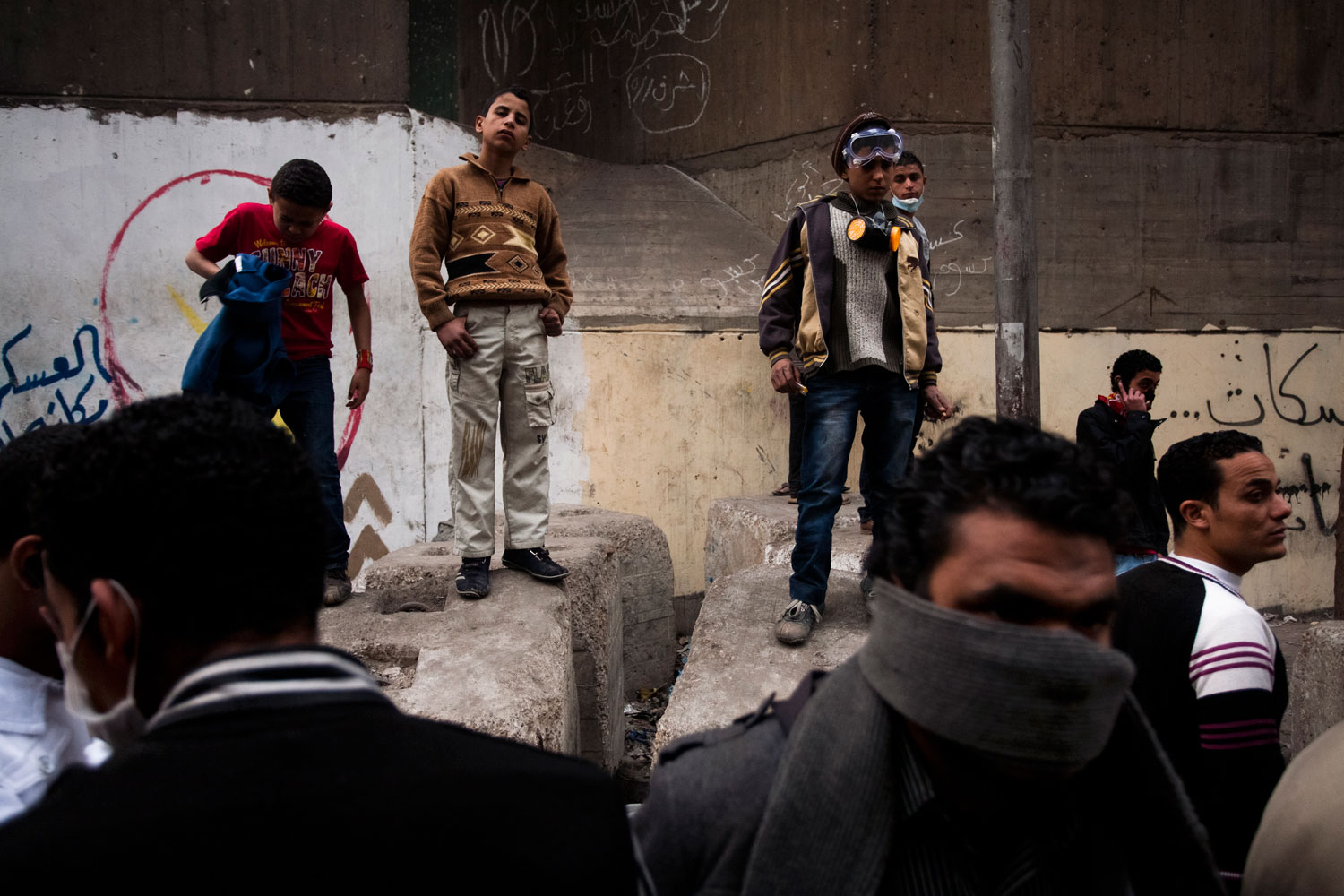 Egyptian boys stand on cement blocks that have been destroyed following street clashes on Mohamed Mahmoud street next to Tahrir Square.