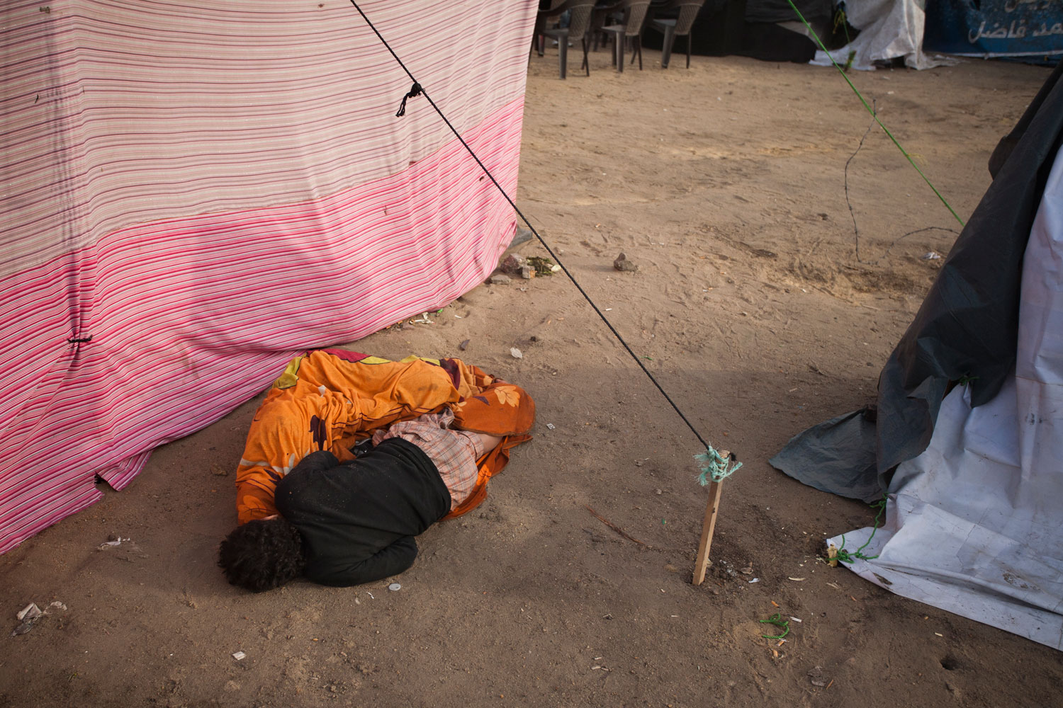 Two boys sleep during the day in the tent city in Tahrir.