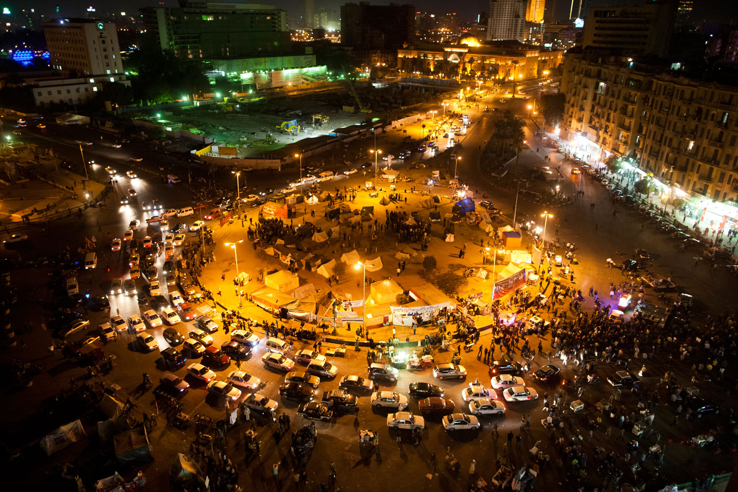 A view of Tahrir Square with a small number of protesters, street vendors and cars, on the one-year anniversary of—and at approximately the same time as—when President Mubarak stepped down.