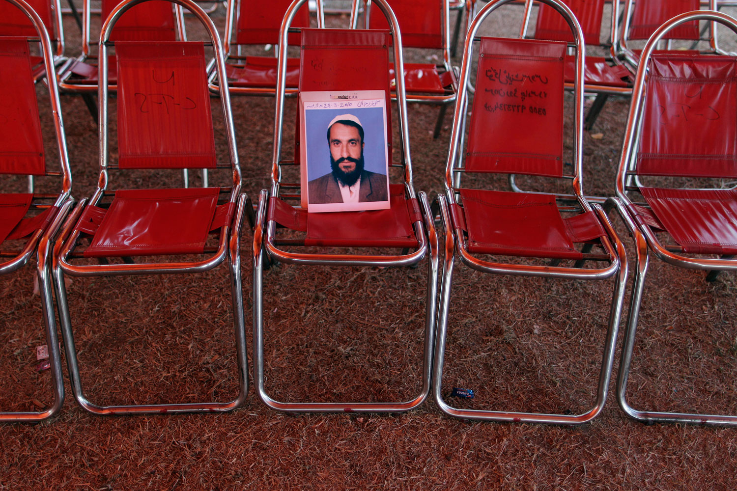 Feb. 24, 2012. A photograph of Pakistani Gulzar Jaan Ghullzir Jan, 35, who went missing in 2010, is left on a chair inside a tent near the parliament in Islamabad, Pakistan. The Supreme Court has now given the families a measure of hope by bringing a landmark case against the Inter-Services Intelligence agency, the country's most feared spy network and suspected to be behind most of the abductions.