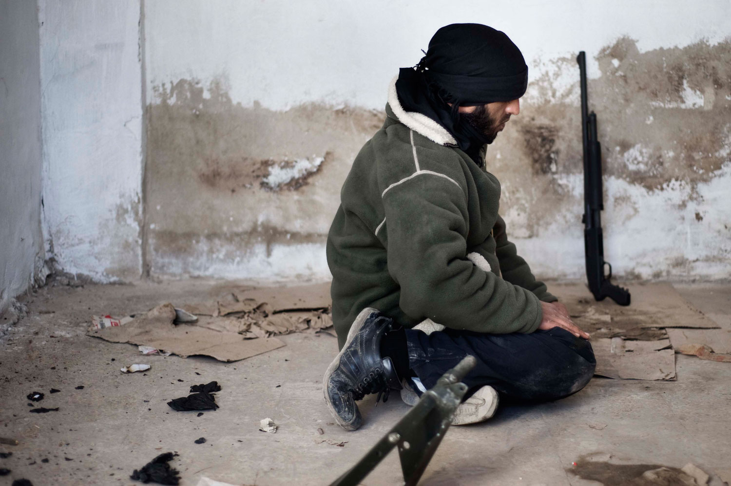 Feb. 9, 2012. A member of the Free Syrian Army prays near a Free Syrian Army checkpoint in al-Qsair.