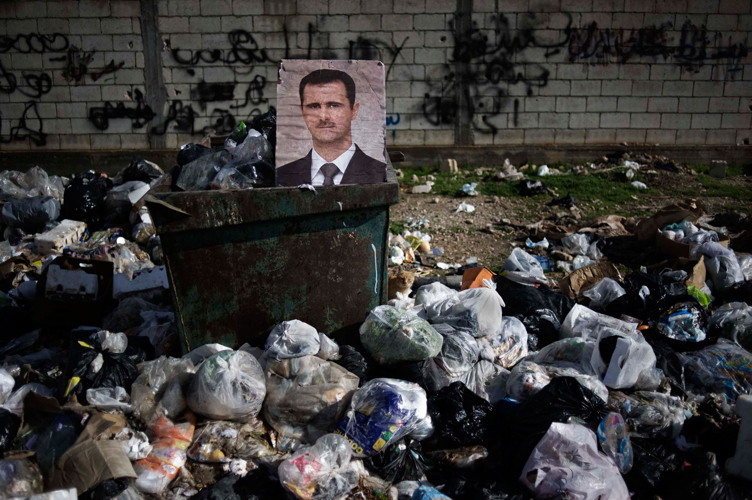 Feb. 10, 2012. A portrait of Syrian President Bashar al-Assad among the trash in al-Qsair.