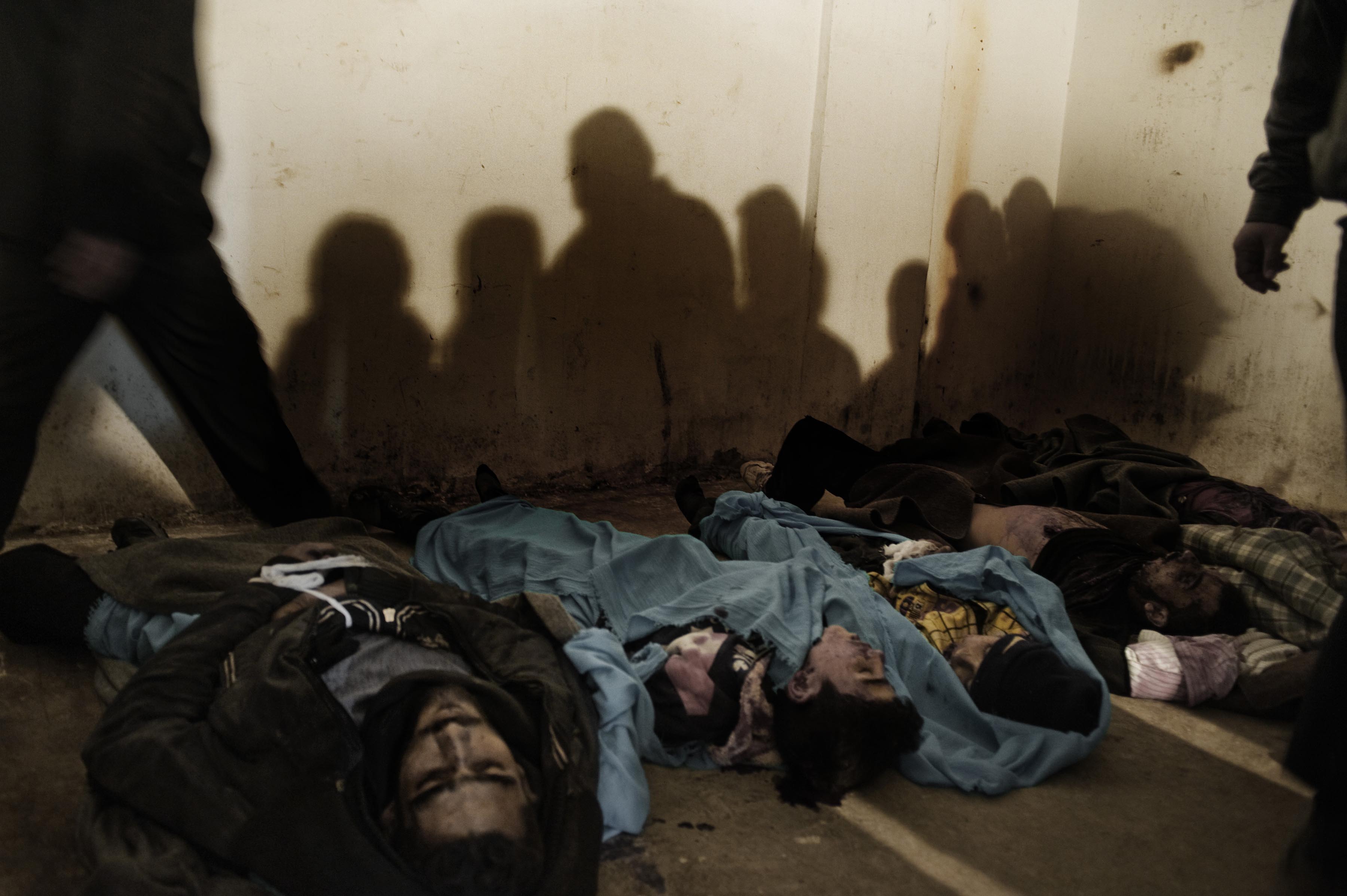 Feb. 20, 2012. Five dead bodies of civilians killed by a mortar, among them two children, lie in a refrigerator used by the resistance as a morgue in Homs Province.