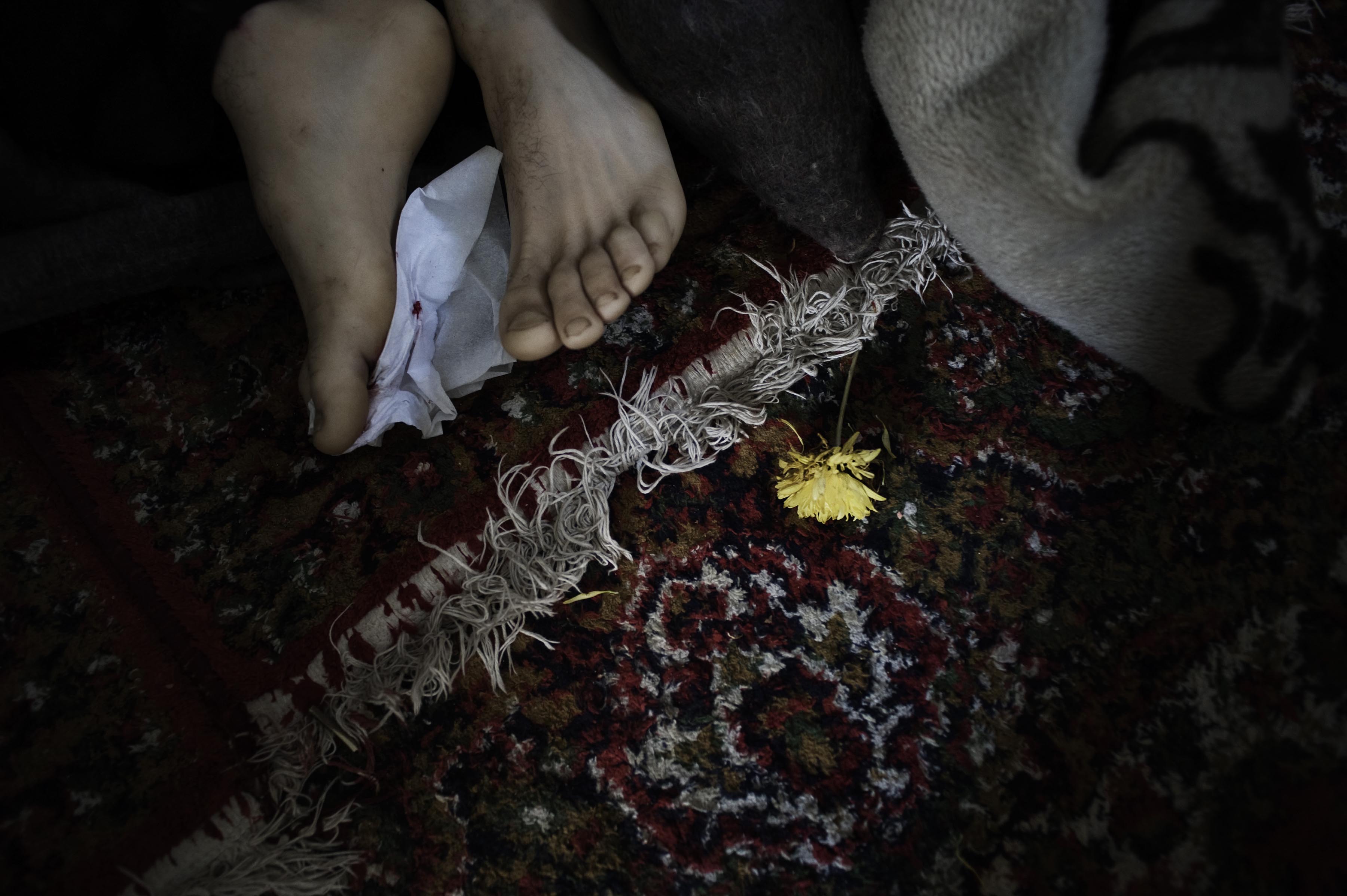 Feb. 20, 2012. The feet of one of the five dead bodies of civilians killed by a mortar explosion in his house, Homs Province.