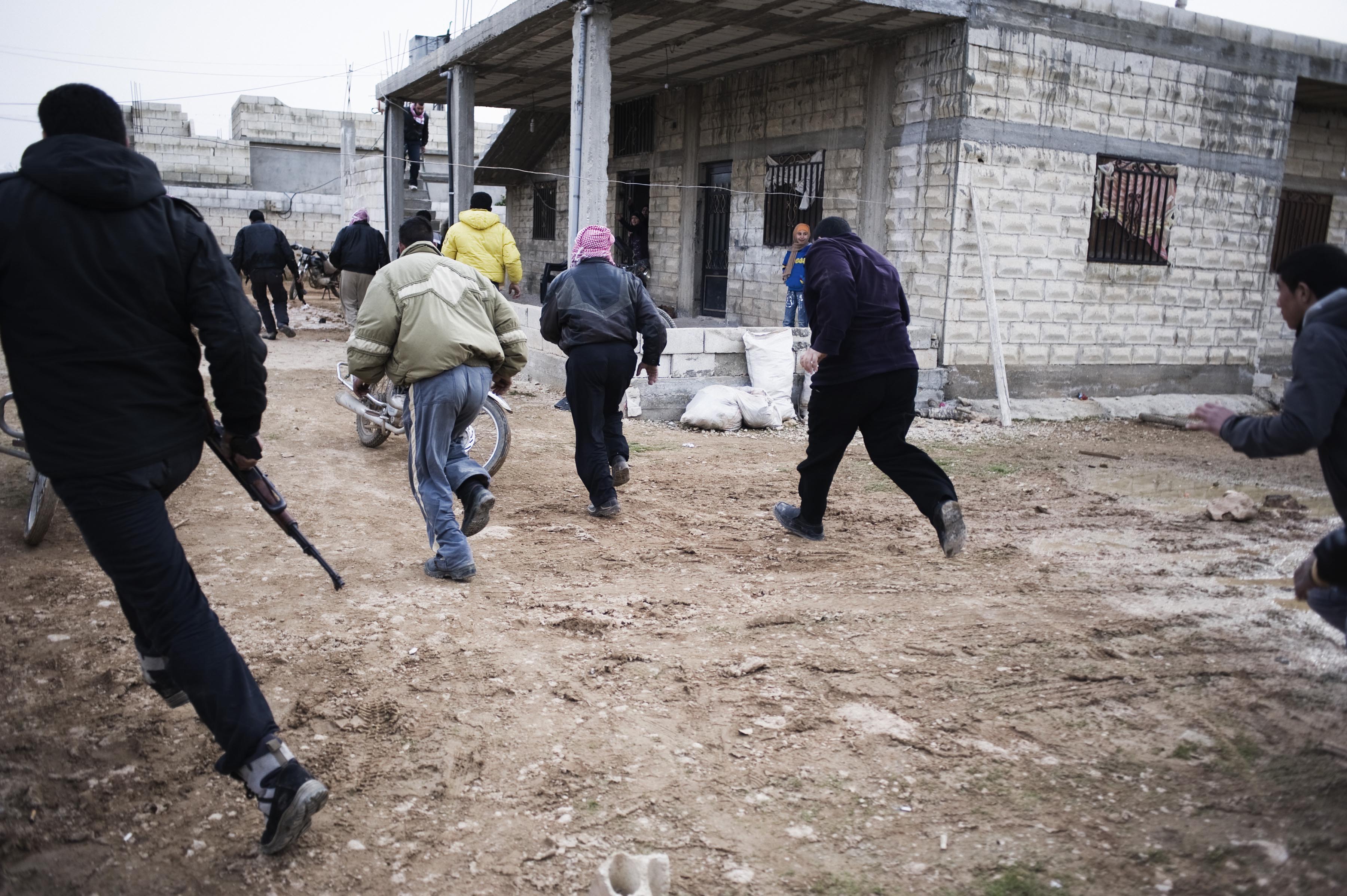 Feb. 22, 2012. Rebels run away from heavy shelling in Homs Province.