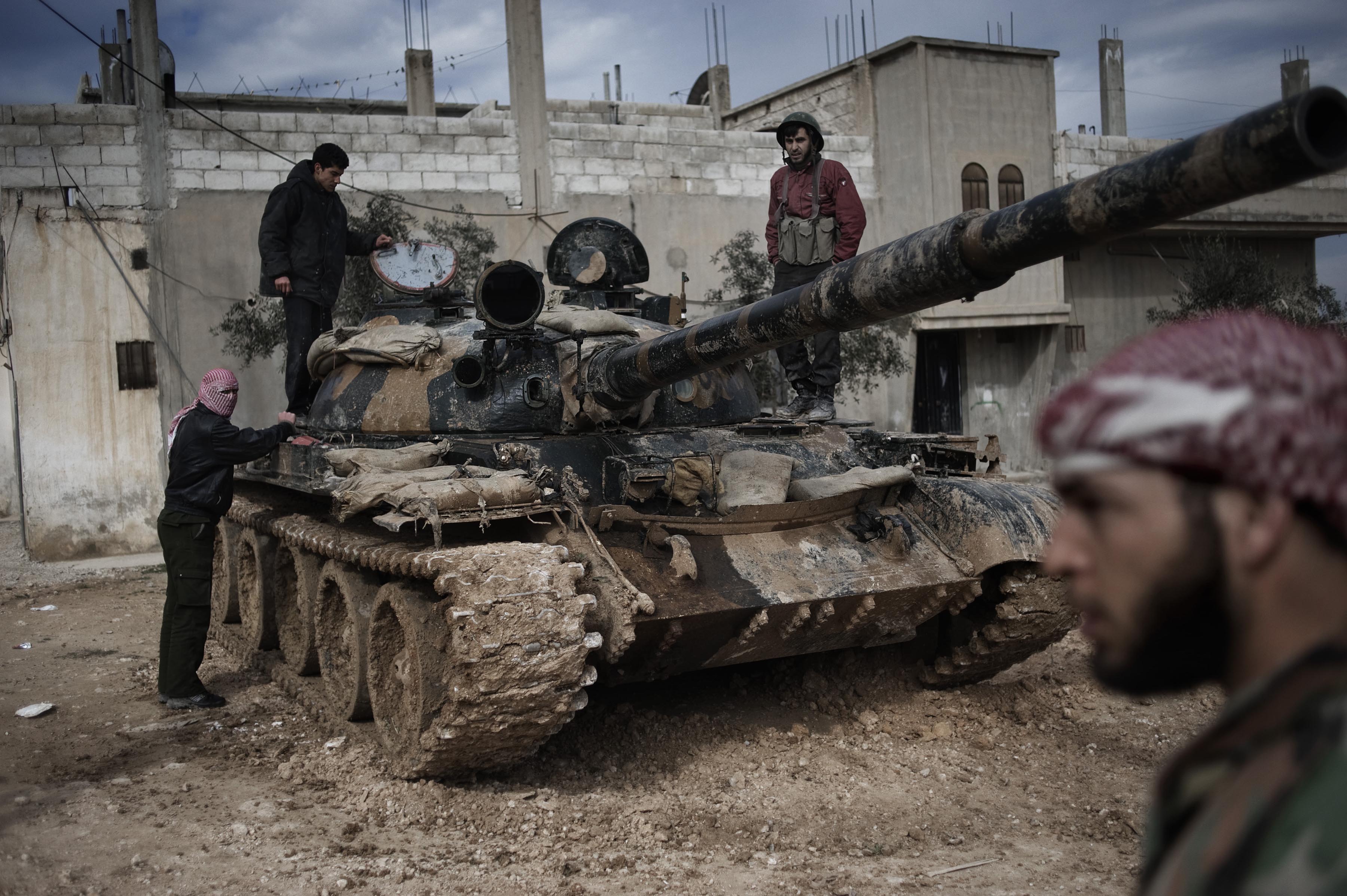 Feb. 23, 2012. A Free Syrian Army member prepares to fight with a tank whose crew defected from government forces in al-Qsair.