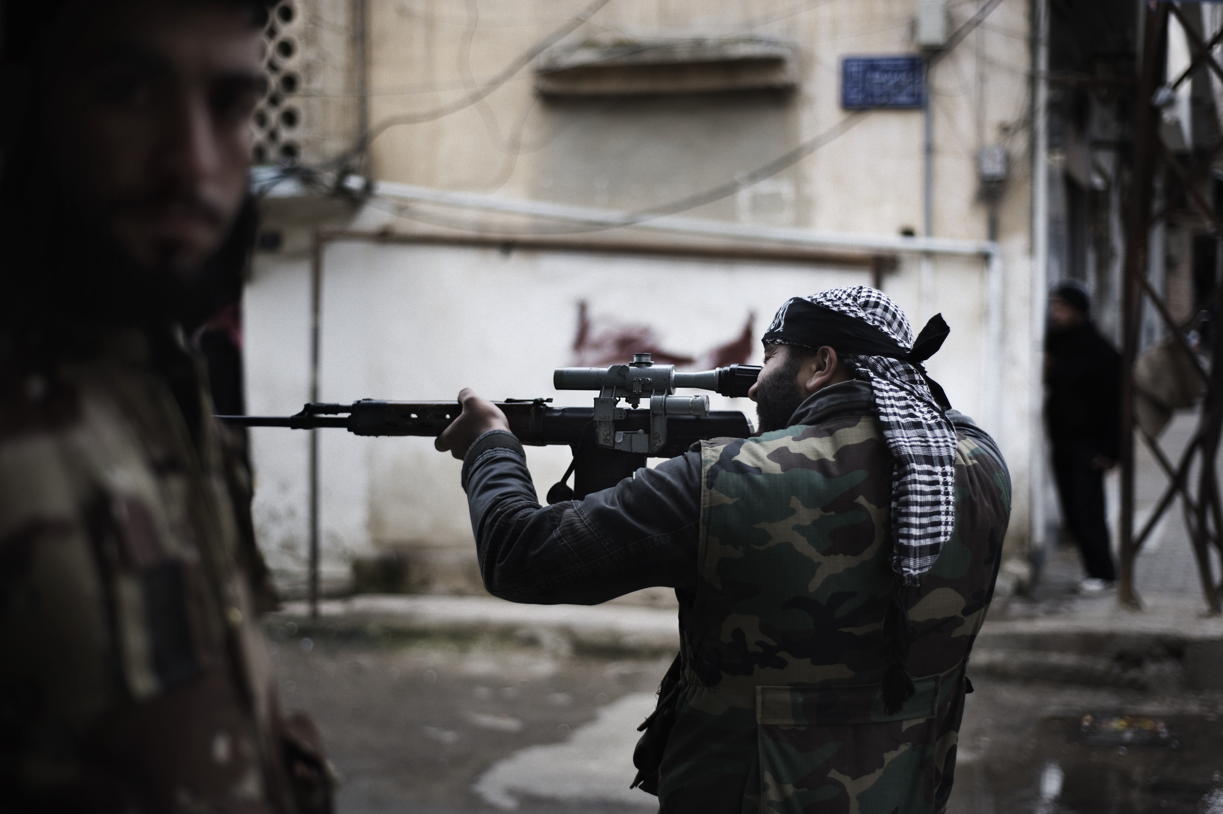 Feb. 24, 2012. A Free Syrian Army fighter is seen as he aims at an Al Assad Forces position in al-Qsair.