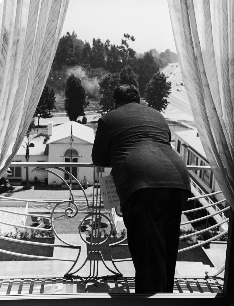 Alfred Hitchcock looks out over the grounds of the Beverly-Wilshire Hotel in 1939.