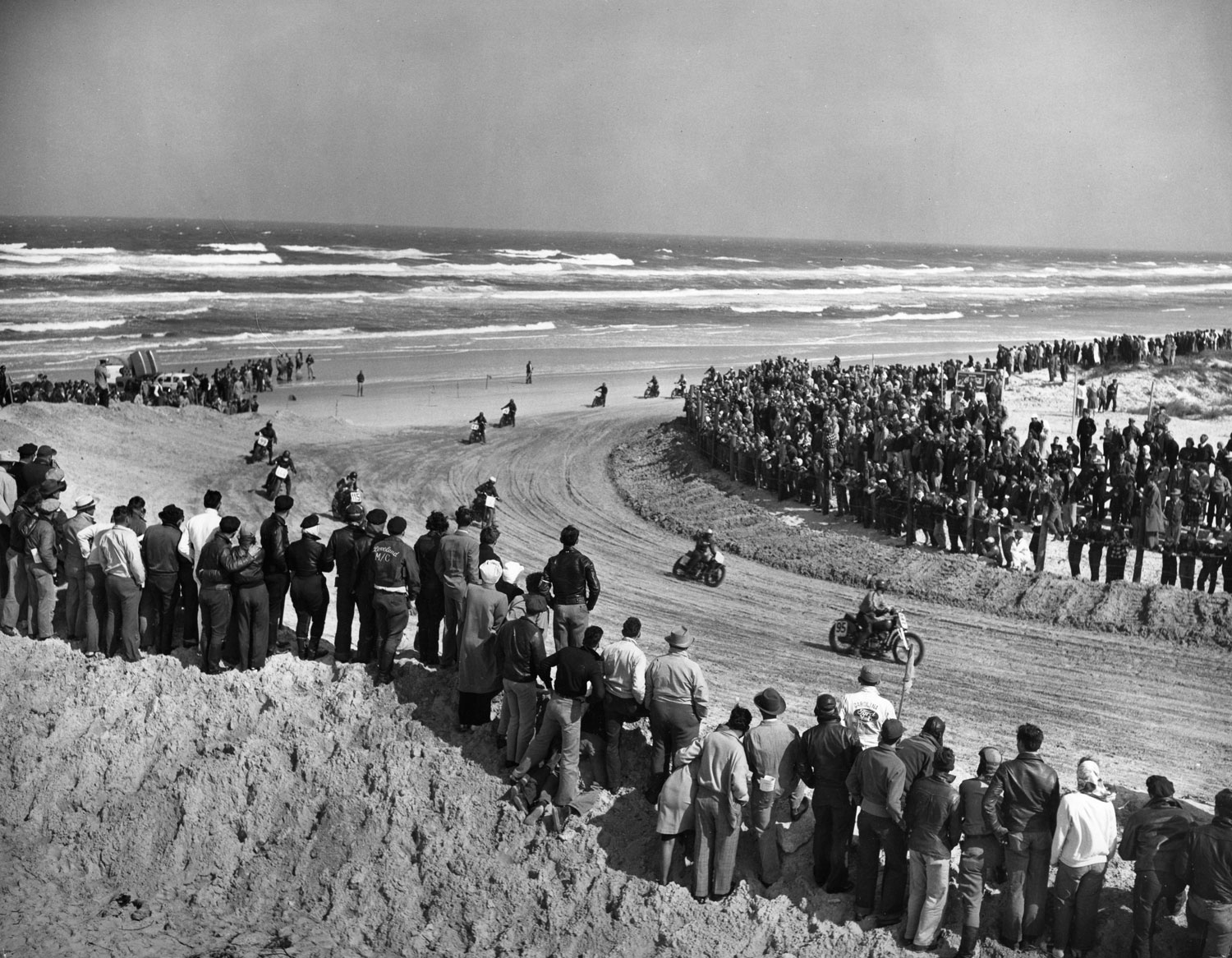 Spectators stand on the beach to watch the Daytona Beach Motorcycle Races in March 1948.