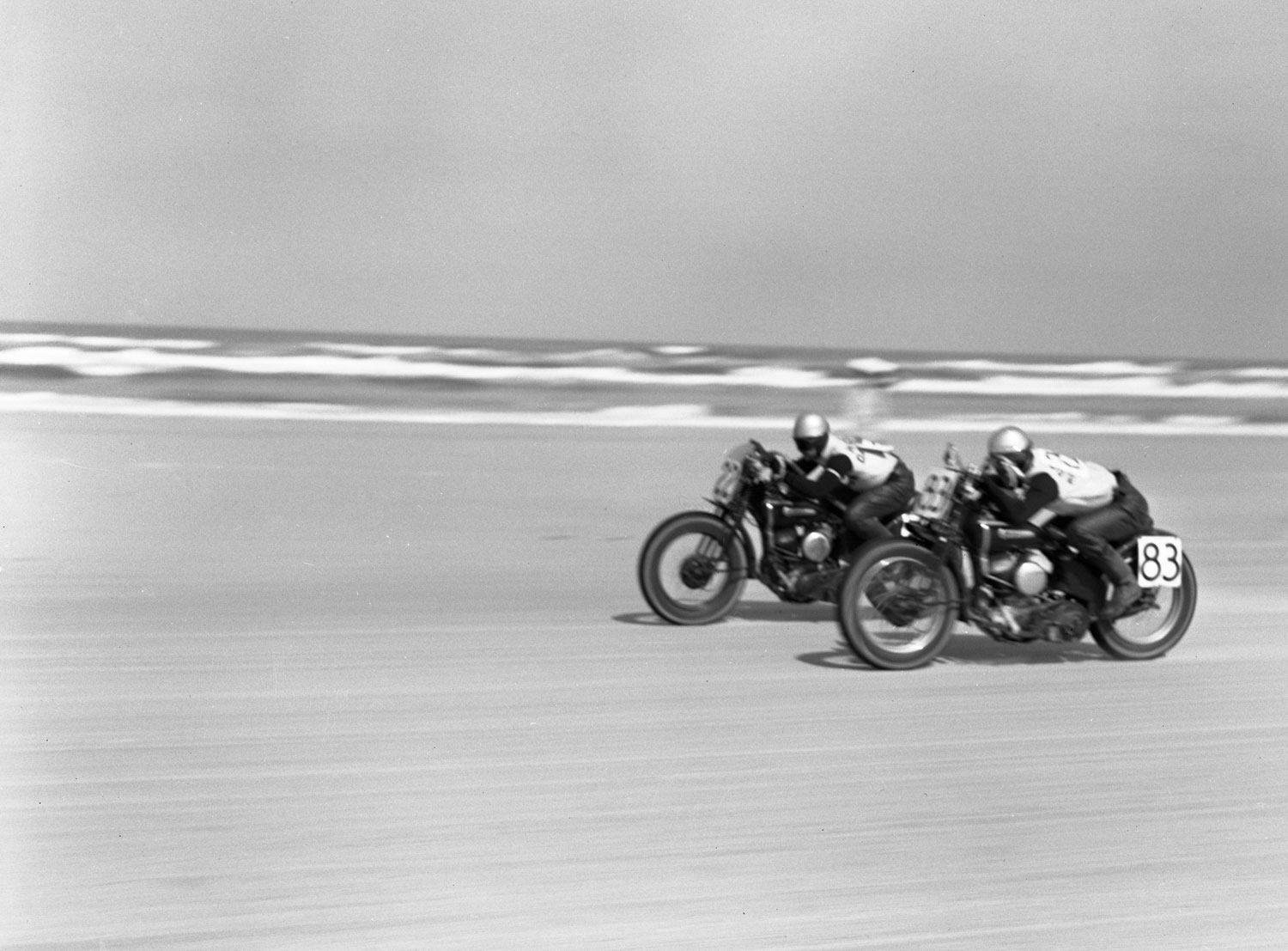 Low on their bikes, two racers speed neck and neck across the sand during the Daytona 200, Daytona Beach, Florida, in March 1948.