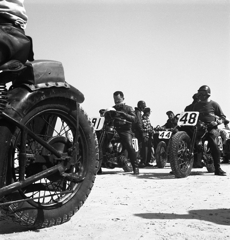 Low-angle view of some of the participants in the Daytona 200 motorcycle race as they sit astride their bikes, Daytona Beach, Florida, March 1948.
