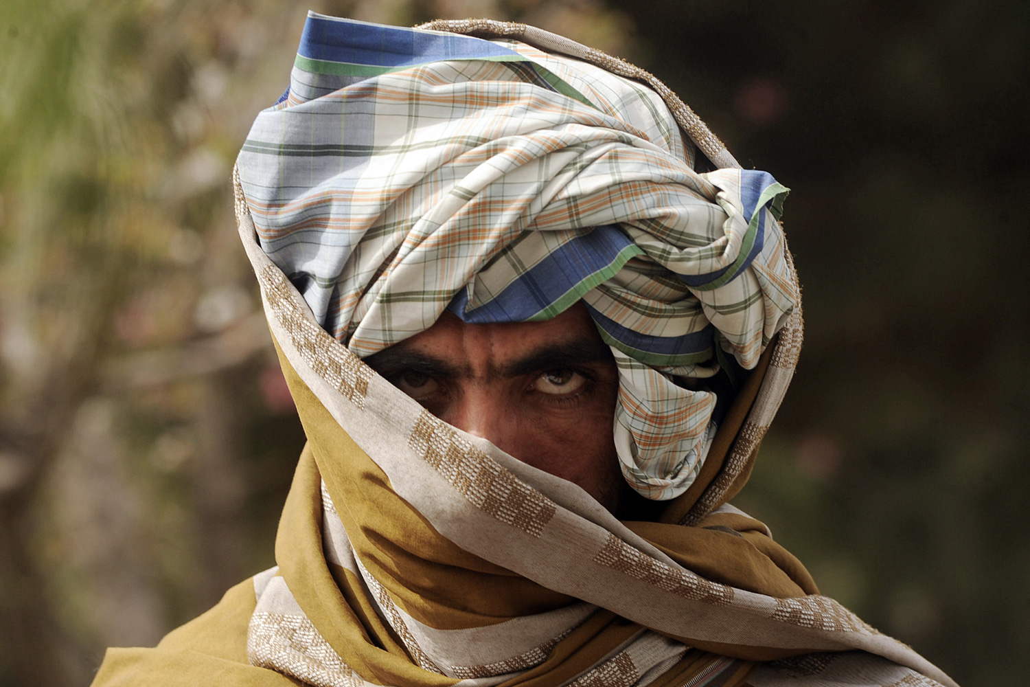 March 26, 2012. A former Taliban fighter looks on after joining Afghan government forces during a ceremony in Herat province, Afghanistan.