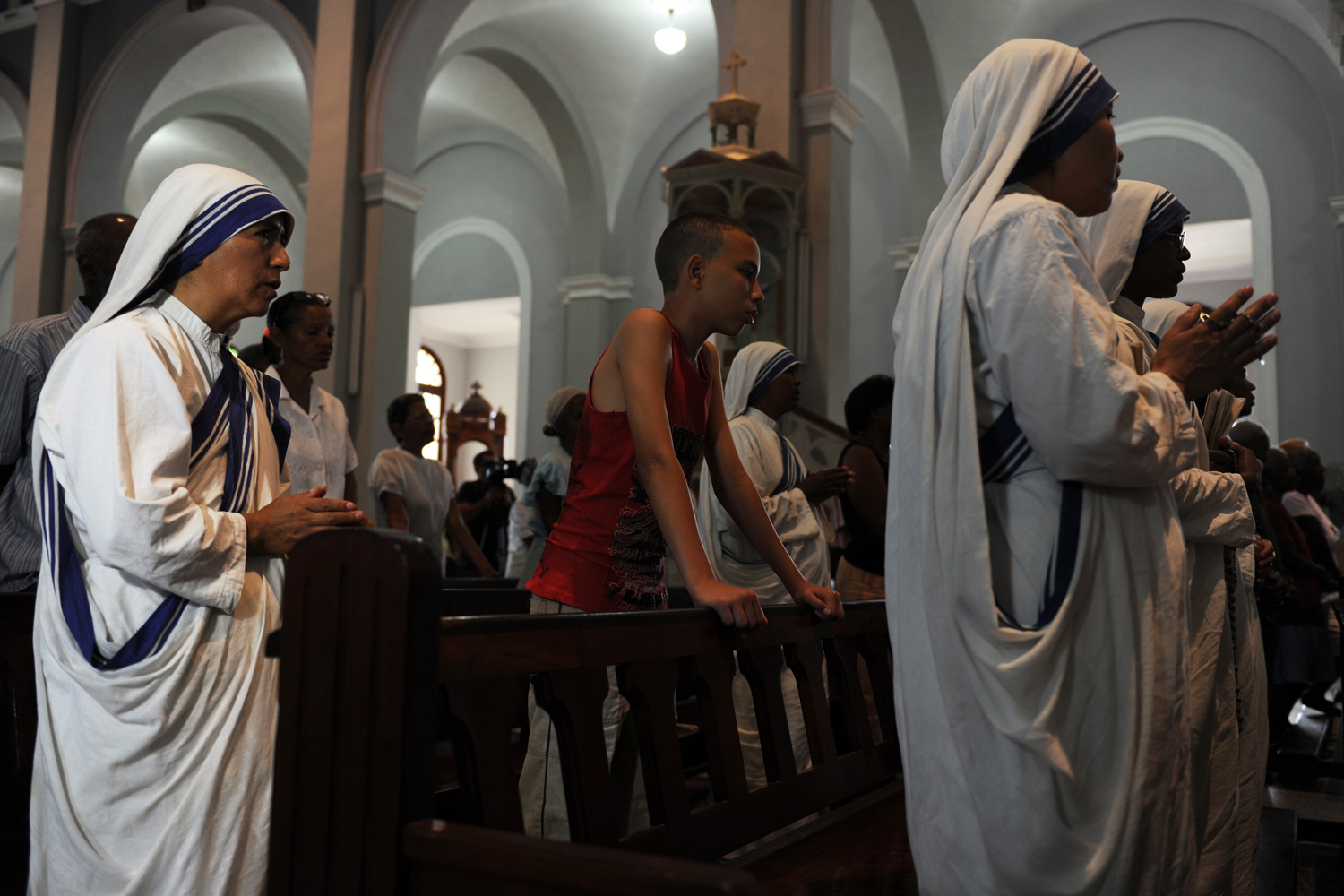 March 25, 2012. Nuns attend a mass at the Church of Charity in El Cobre, southeast of Havana.