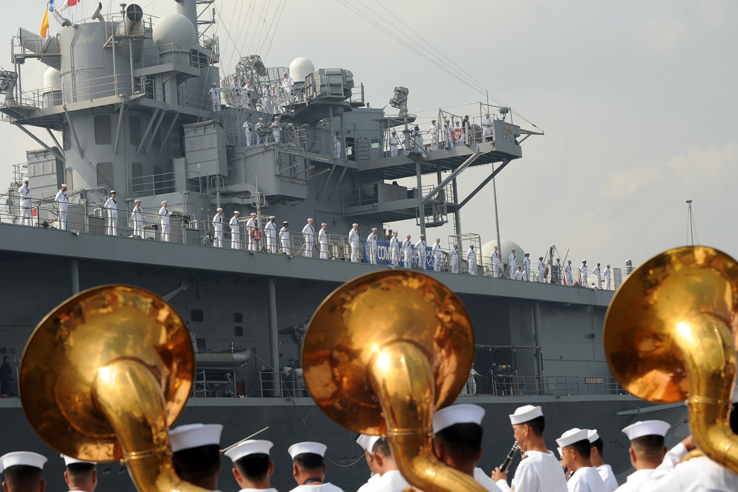 March 23, 2012. Philippine Navy personnel welcome the USS BlueRidge and its crew as it prepares to dock at the international port in Manila.