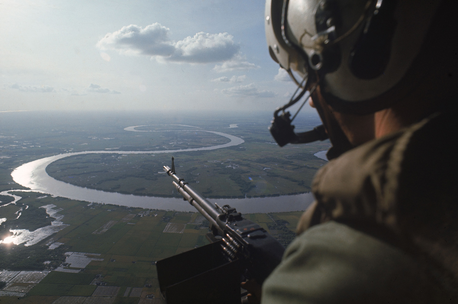 Machine gunner in helicopter on patrol over the Mekong Delta in 1967.