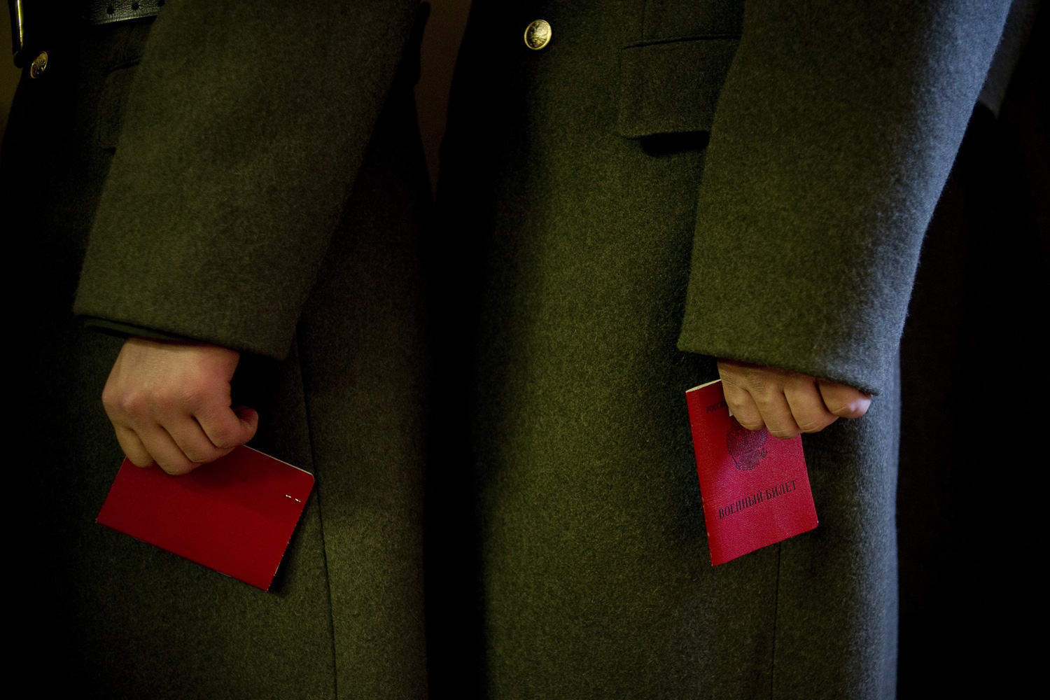 March 4, 2012. Russian soldiers hold their identification at a polling station in Moscow.