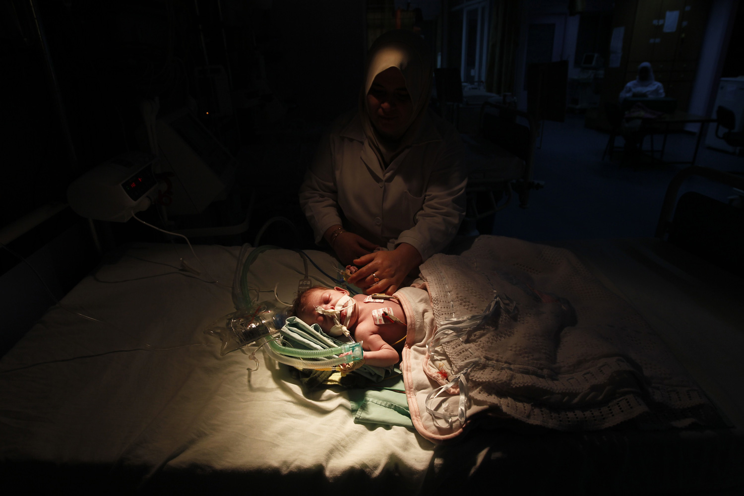 March 27, 2012. A Palestinian baby receives treatment at the intensive care unit at a hospital where they are using generators to maintain medical support units in Gaza City.