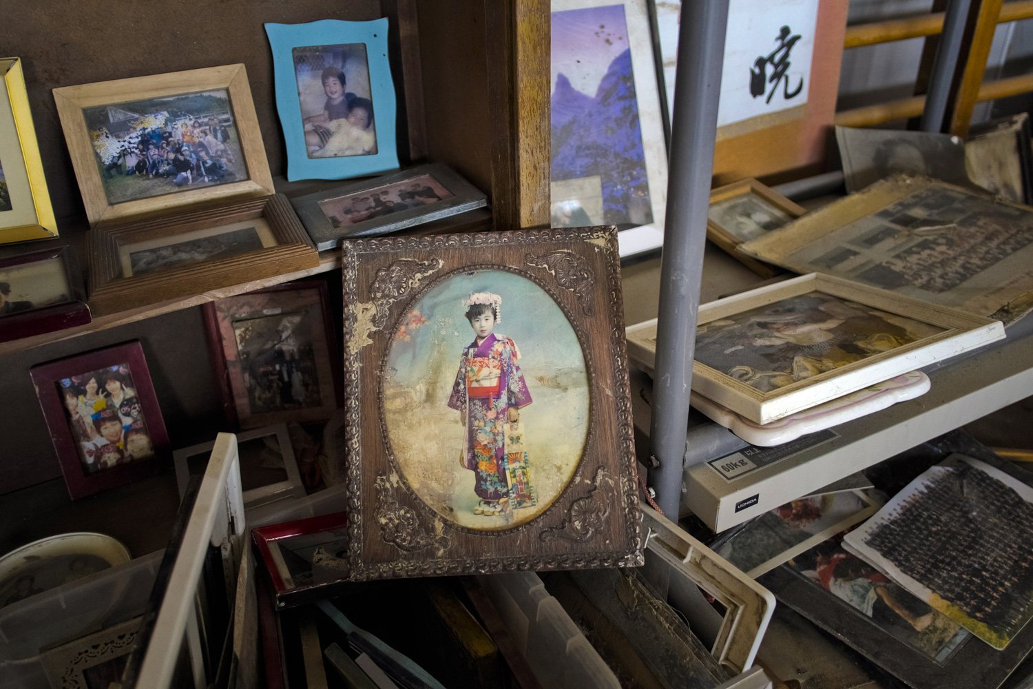 March 2, 2012. Photographs lie in a school gymnasium set up as a collection site for lost possessions from last year's tsunami in the Yuriage area of Natori, Japan.