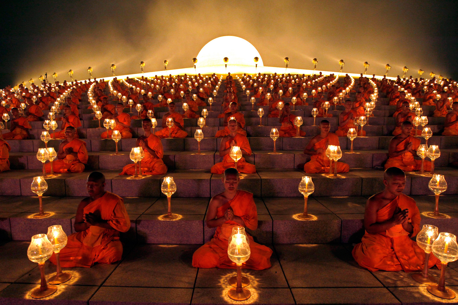 March 7, 2012. Thousands of Thai Buddhist monks chant during lantern lighting to celebrate Makha Bucha day at Dhammakaya Temple in Pathum Thani province, on the outskirts of Bangkok.