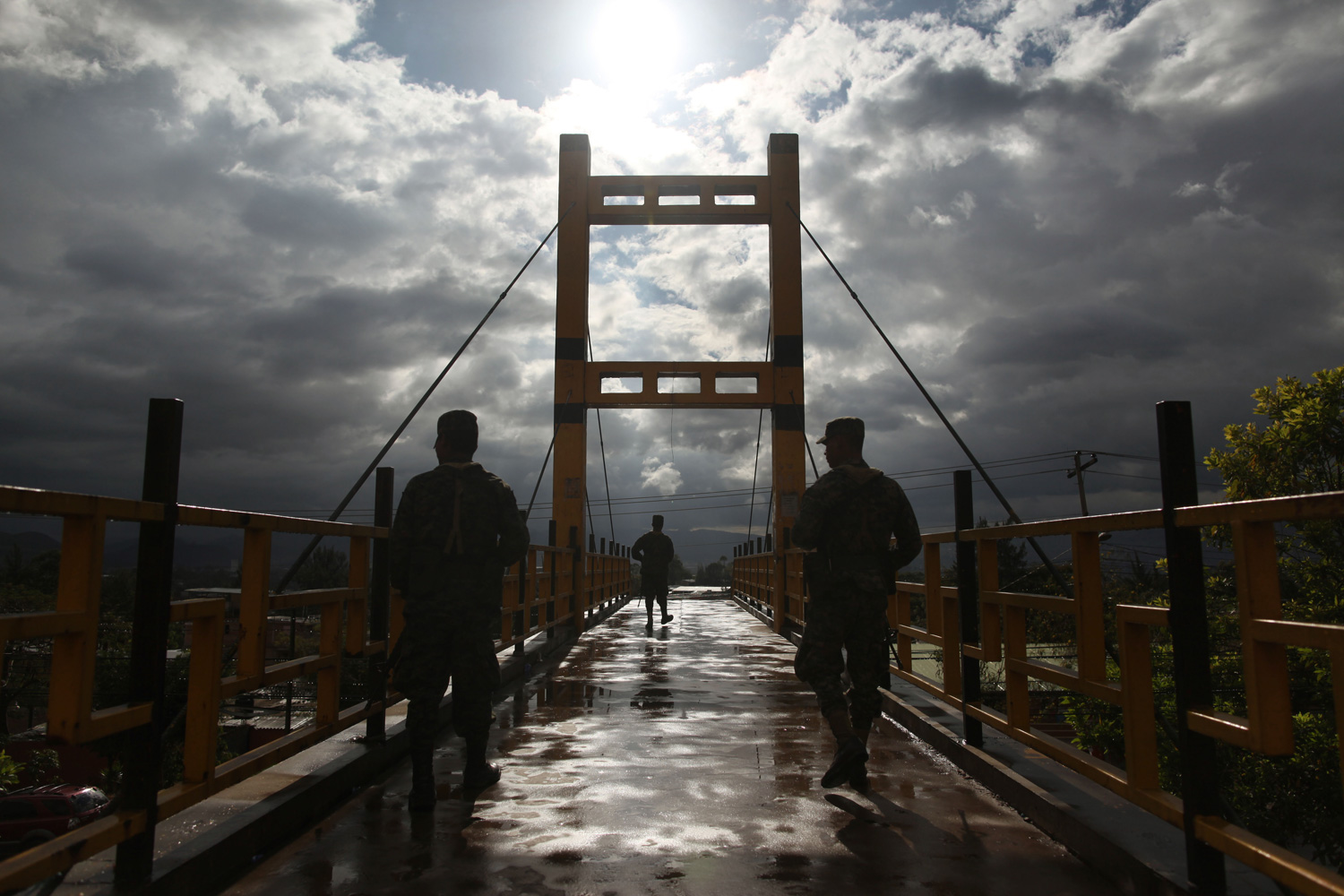 March 5, 2012. Soldiers stand guard on a pedestrian bridge in Tegucigalpa, Honduras.