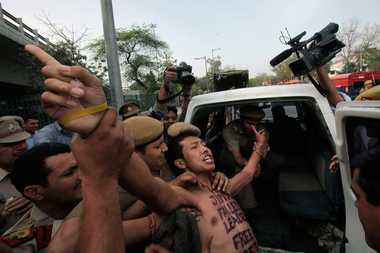 March 28, 2012. A Tibetan exile is detained by police during a protest against the visit of Chinese President Hu Jintao, outside the hotel where Hu is staying, in New Delhi.