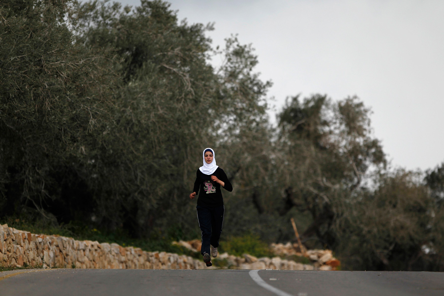 March 27, 2012. Palestinian runner Worood Maslaha, 20, trains in the West Bank village of Asira Ash-Shamaliya near Nablus.