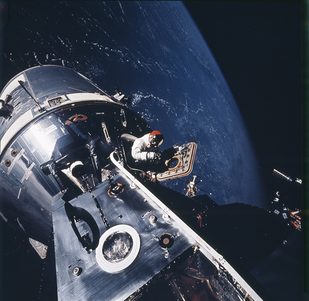 Apollo 9, March 1969. On the fourth day of the mission, astronaut David Scott stood in the open hatch of the command module and scanned the blue earth below.
