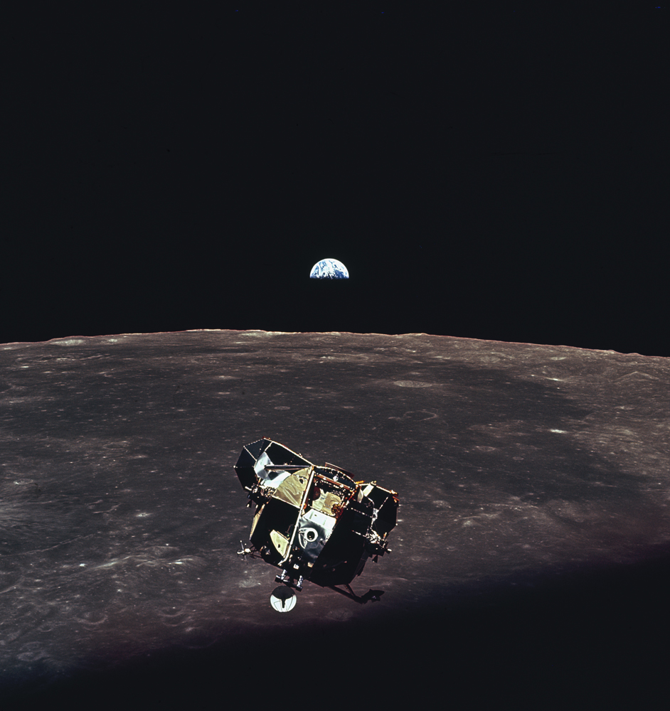 With the Earth visible in the distance above the moon's bleak horizon, Apollo 11's lunar module ascends toward the command module (piloted by astronaut Michael Collins while Armstrong and Aldrin were on the lunar surface).