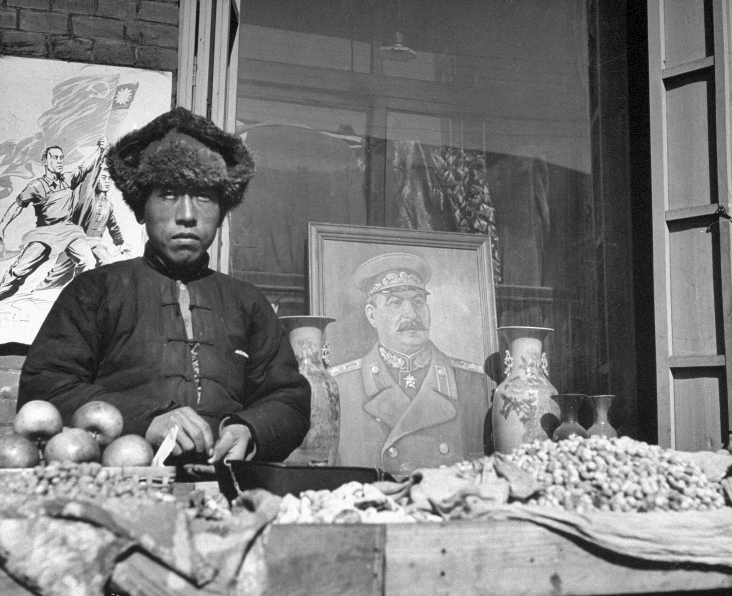 A poster of Stalin hangs in a shop window in Mukden, China, in 1946.