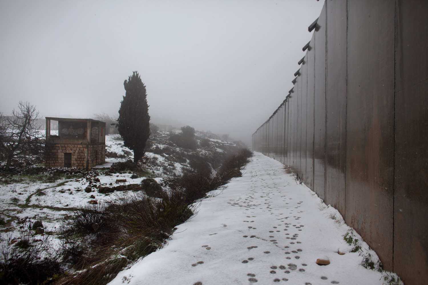 March 2, 2012.  Israel's separation barrier as snow falls near Hebron, West Bank.
