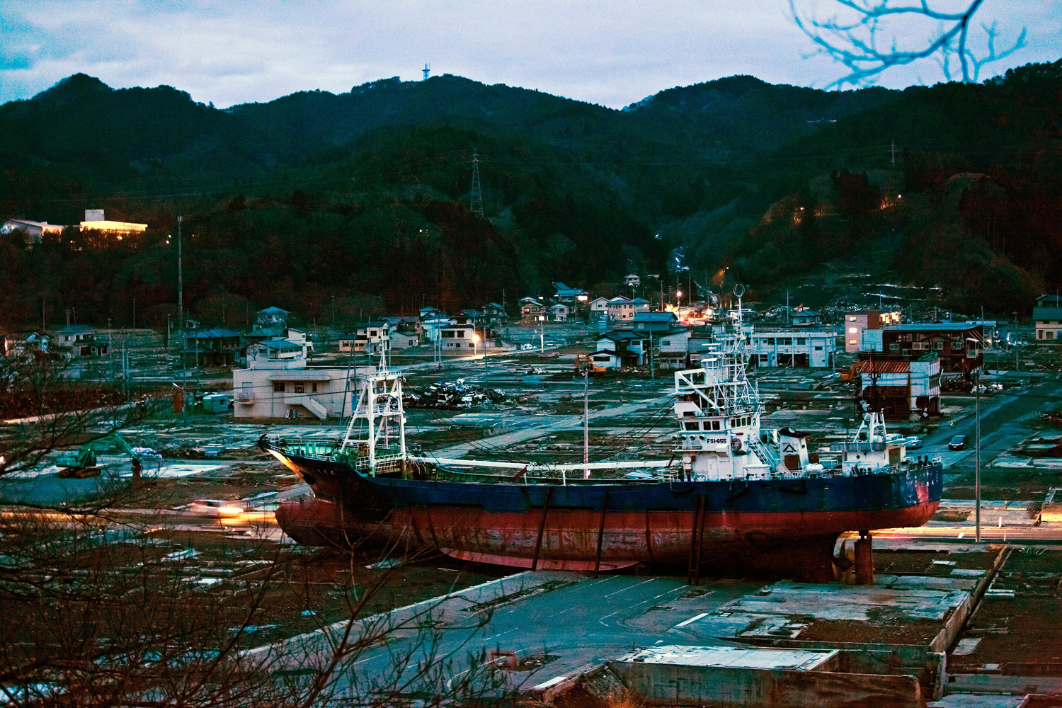 March 6, 2012. A fishing boat, dragged inland during last year's tsunami, sits on the ground in Kesennuma, Japan.