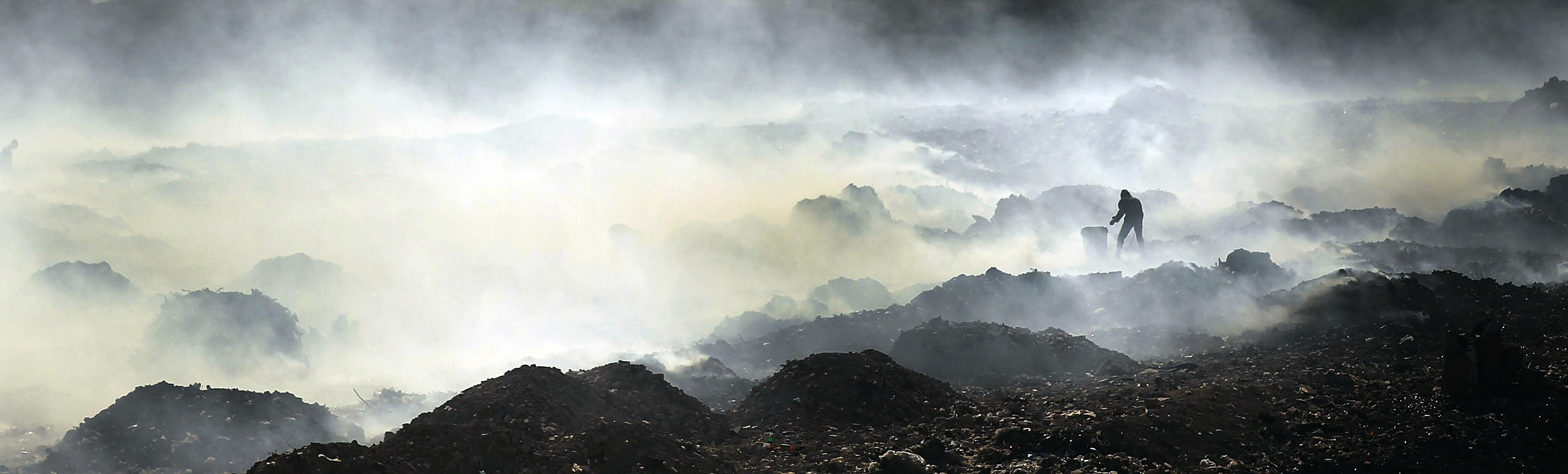 March 7, 2012. A lone man scavenges for recyclable and other usable items at the Trutier dump on the outskirts of Port-au-Prince, Haiti.