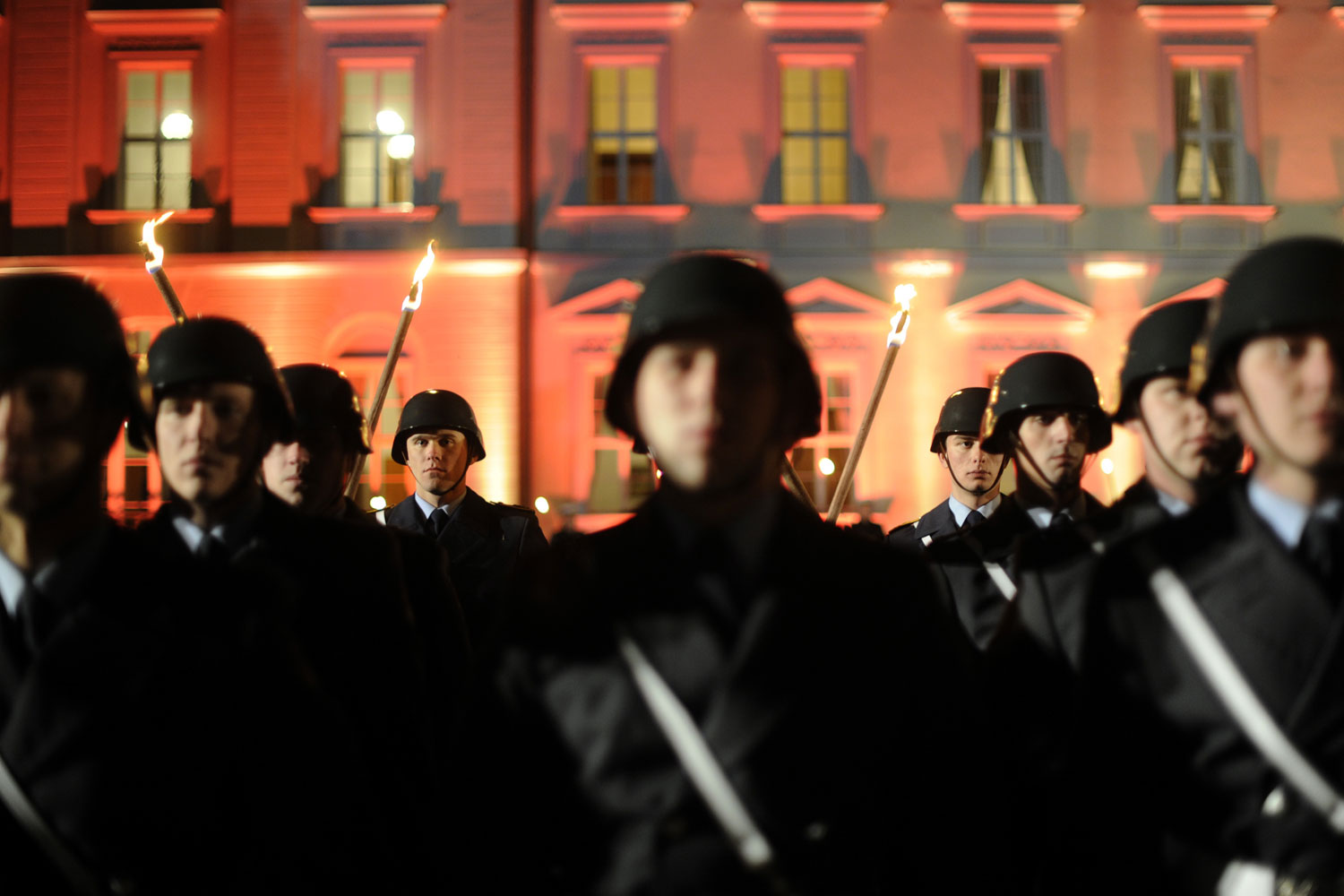 March 8, 2012. Soldiers of the German armed forces Bundeswehr carry torches during a farewell ceremony for the former German President at Bellevue Palace in Berlin.