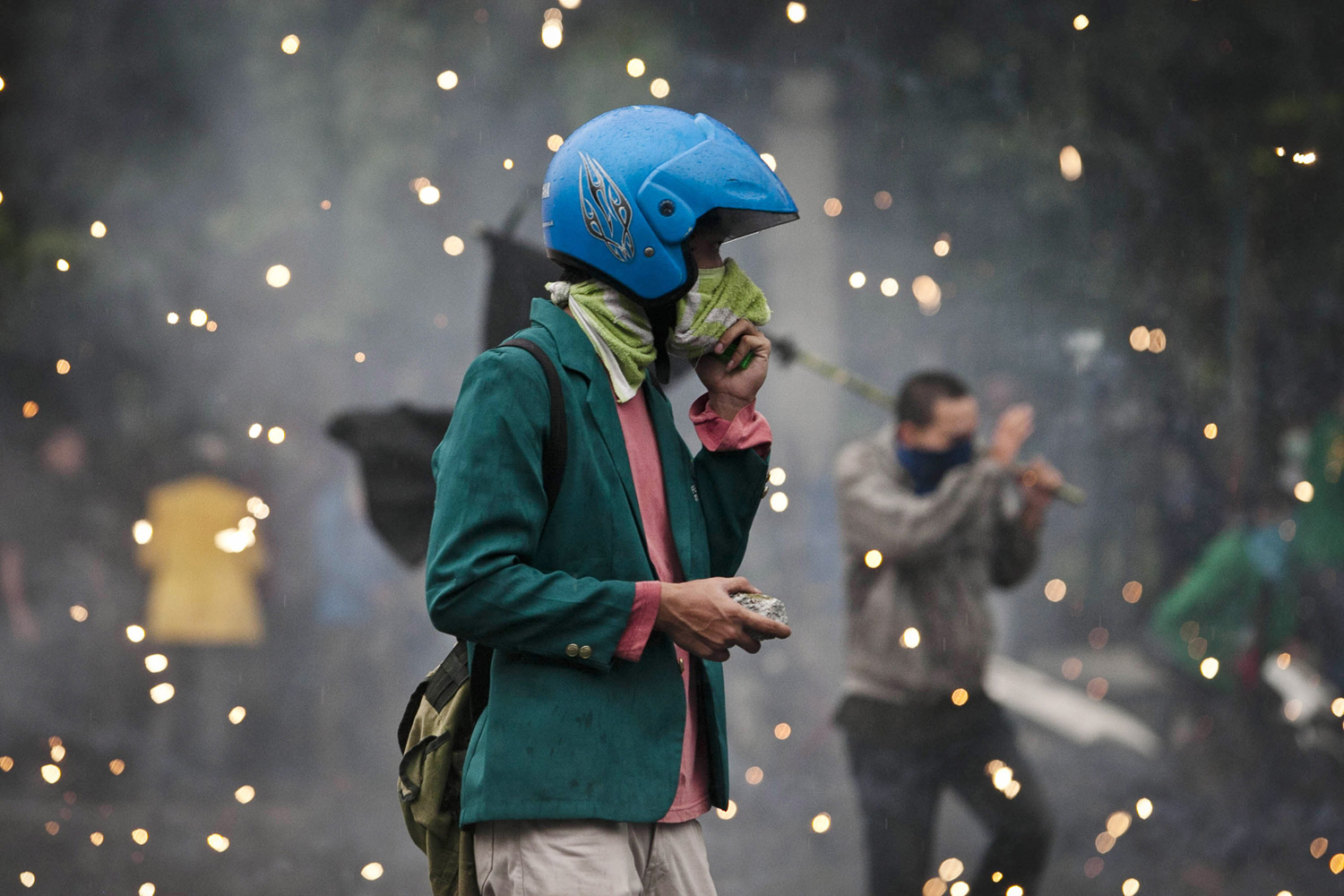 March 27, 2012. A student holds a rock during clashes with police during protests against planned fuel price hikes in Jakarta.