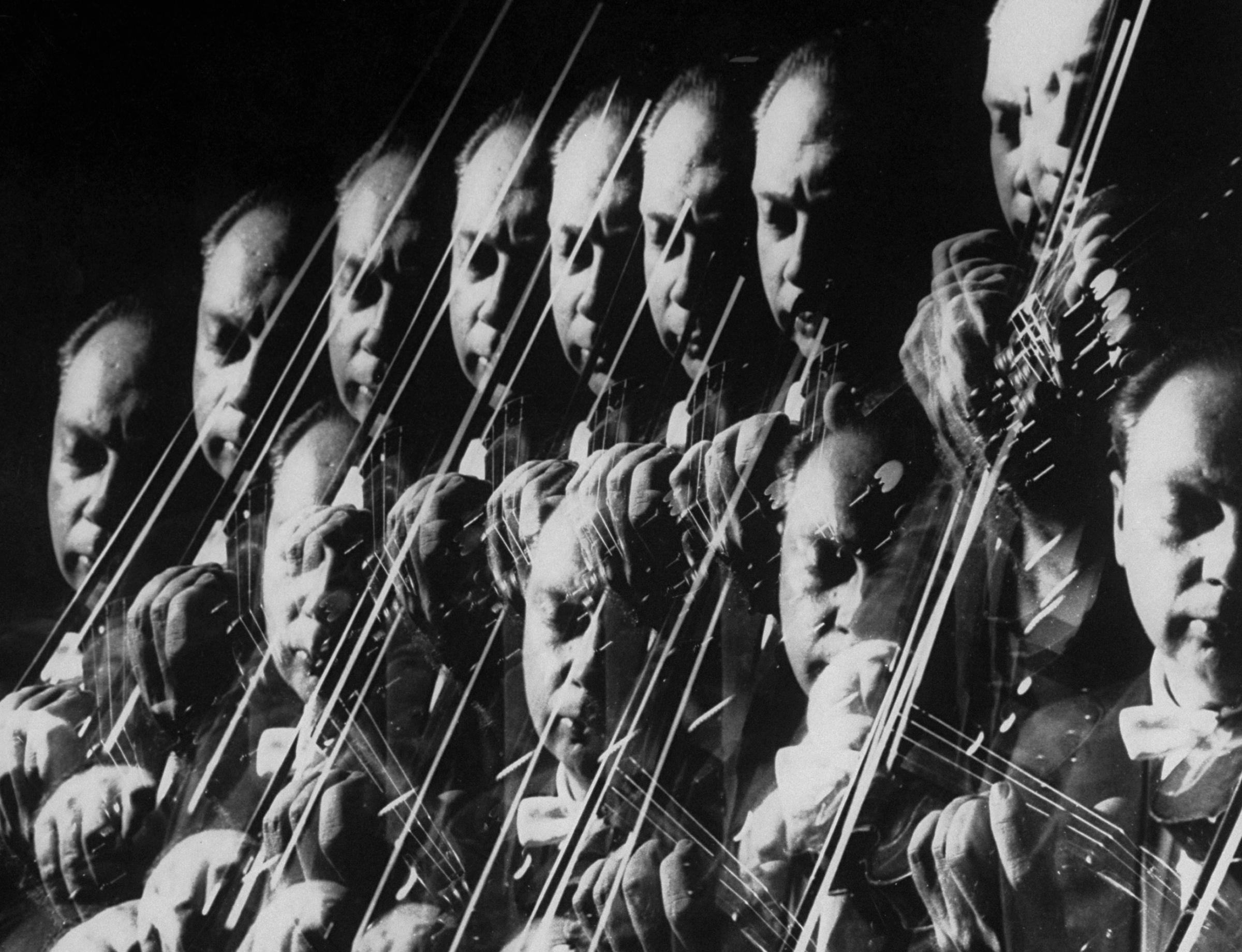 Stroboscopic image showing a repetitive closeup of Isaac Stern playing violin at photographer Gjon Mili's studio in 1959.