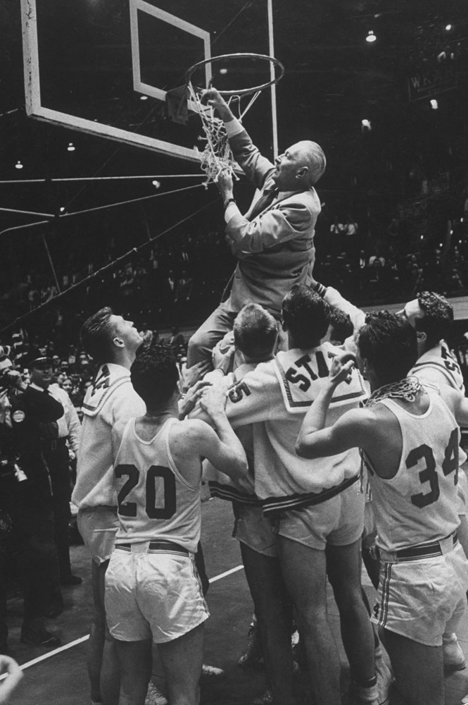 Legendary North Carolina State Wolfpack coach Everett "The Gray Fox" Case cuts down the net after winning the Dixie Classic title in 1959.